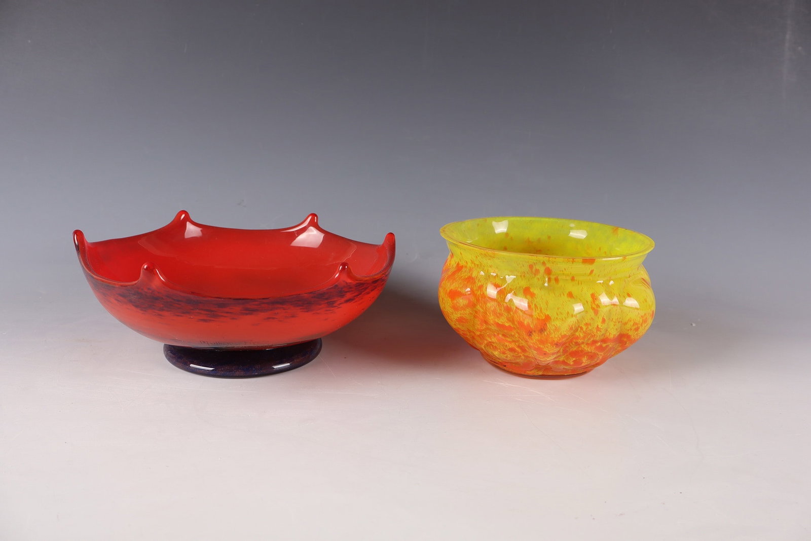 Two bowls: Two bowls among others: Muller Frères, Lunéville, 1920s Colorless glass, with multicolored powder inclusions. A bowl above the foot inscribed MULLER FRES LUNEVILLE (in engraving). The other