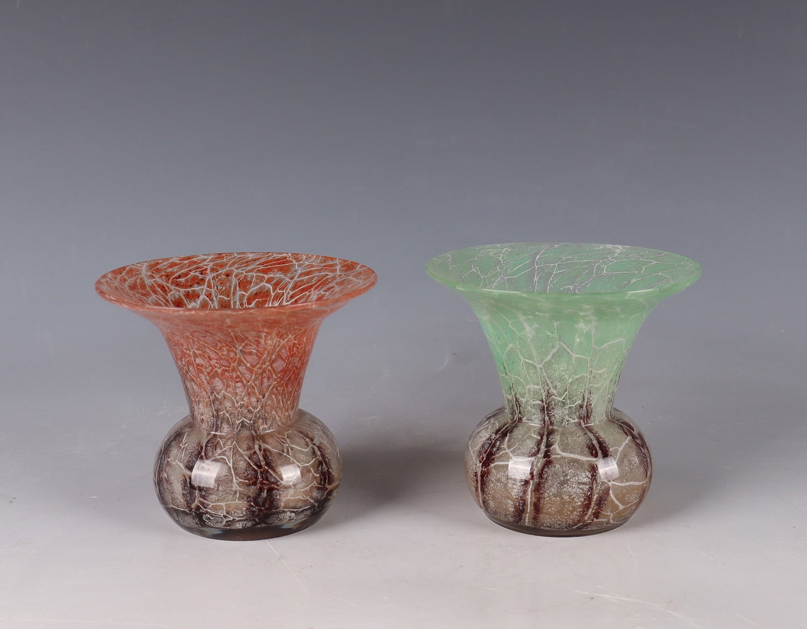 Two Small Vases ''Ikora''- Crystal: Two small vases ''Ikora'' - crystal Karl Wiedmann (decorative technique), WMF, Geislingen, around 1930 Colourless glass, multi-coloured colour and oxide melting between the layers. A vase bumped. H.