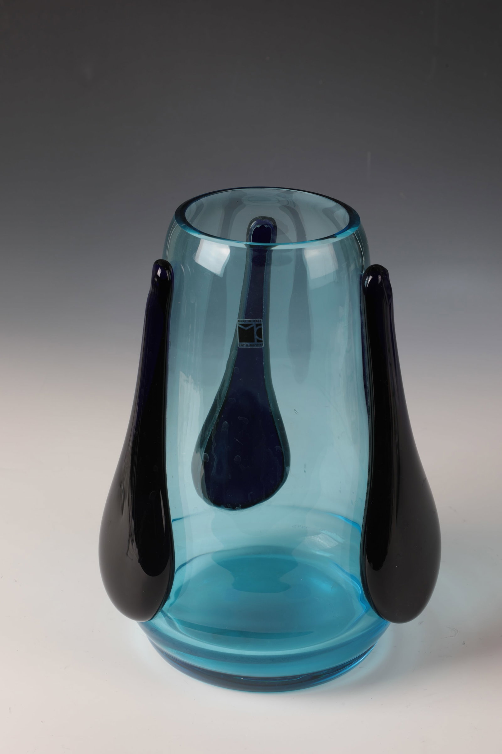 Vase ''Tre Colate'': Vase ''Tre Colate'' Carlo Moretti, Murano, 1995 Light blue glass. On the wall are three teardrop-shaped applications made of dark blue glass. Original manufacturer's label. Signed and dated in
