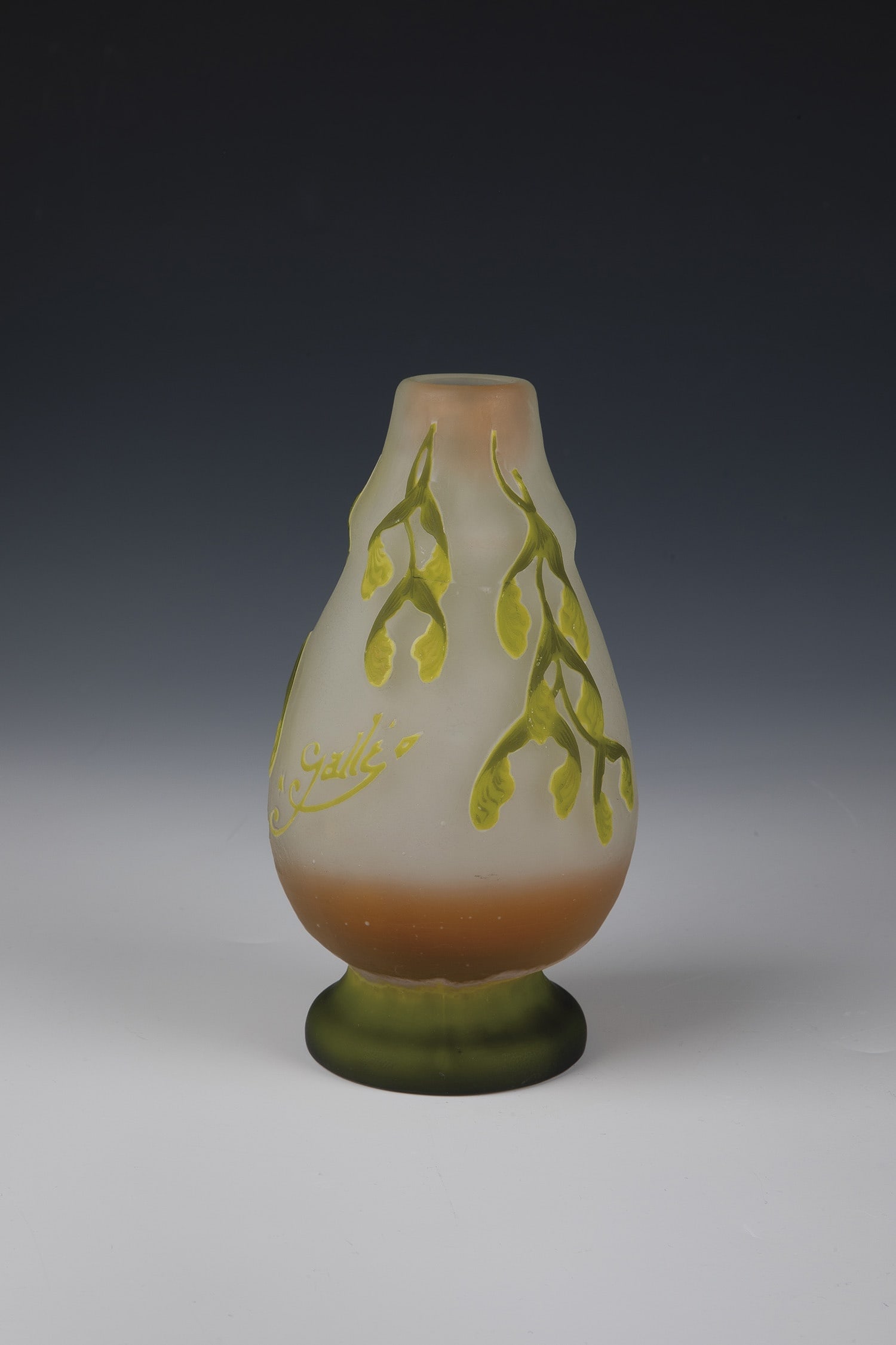 Vase with ash maple: Vase with Ash Maple Emile Gallé, Nancy, c. 1905 Colourless glass with triple overlay in white, yellow and light green, with salmon-coloured partial underlay. Relief etched decoration: branch