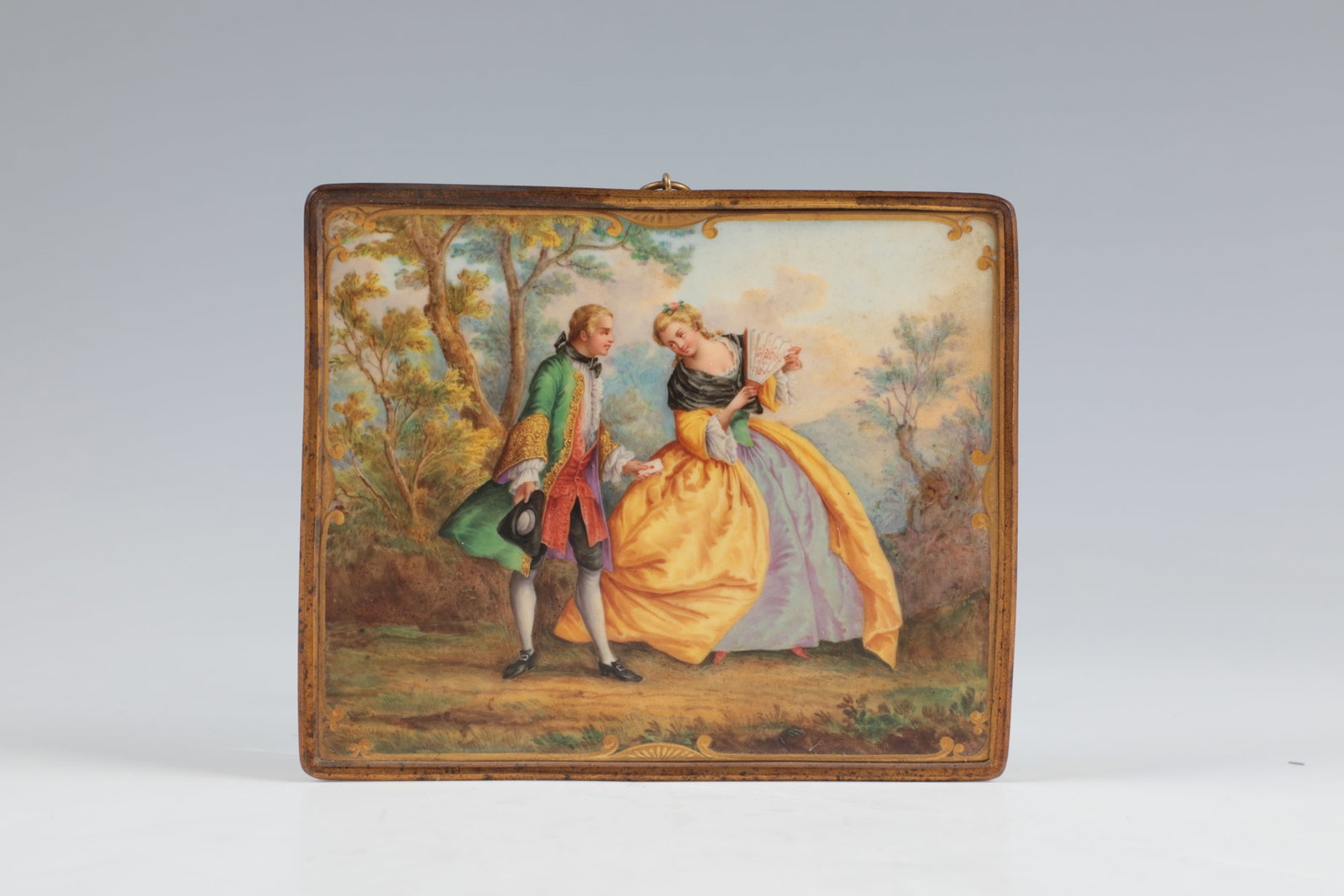 Porcelain Plaque with Gallant Rococo Scene: Porcelain plaque with gallant rococo scene Thuringia, end of the 19th century porcelain plaque in gilded brass frame with hanging loop. Finely polychrome depiction of a courtly couple in a park landsc