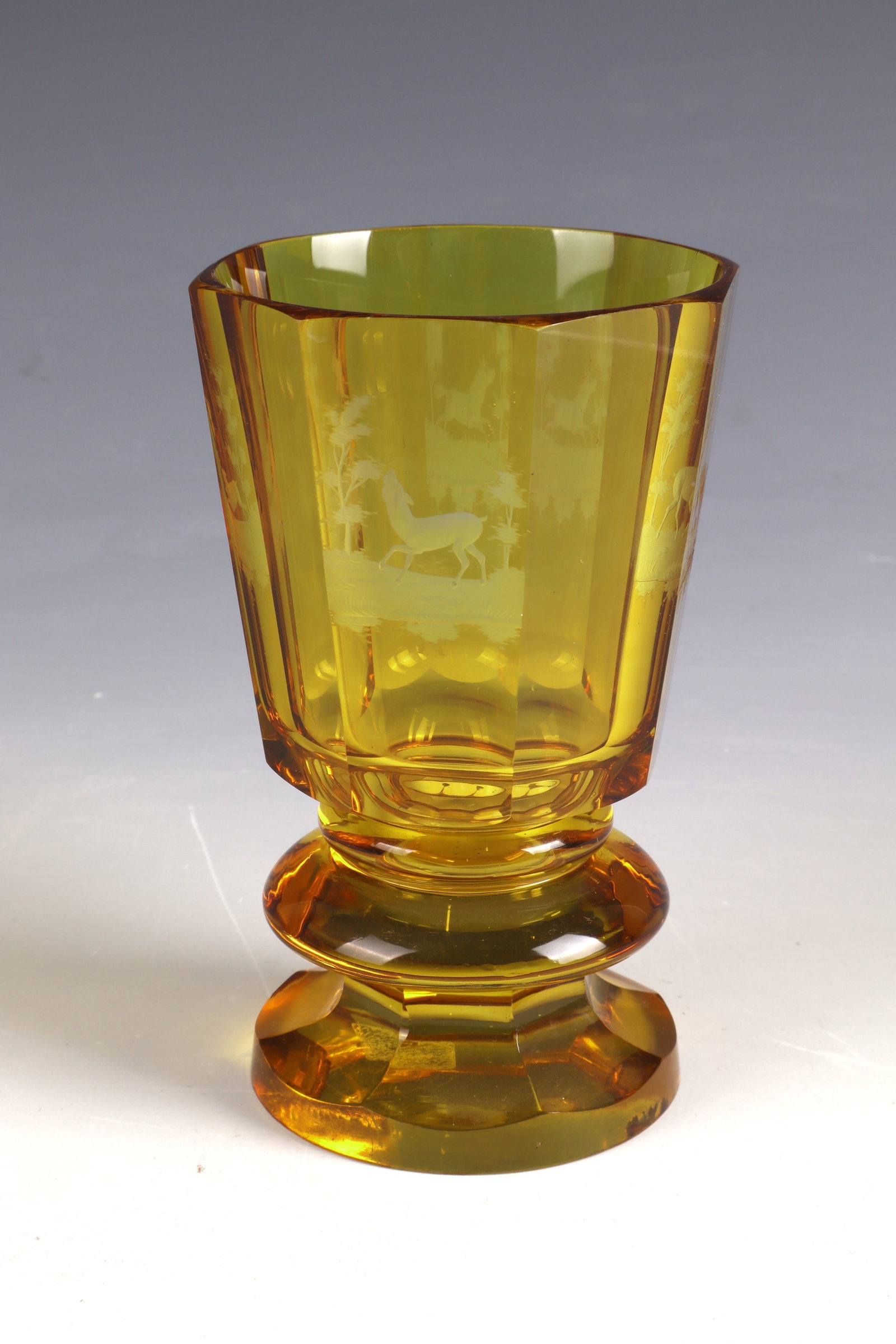 Foot cup: Foot cup Bohemia, mid-19th century Colourless, amber-coloured glazed and cut decorated glass. Surrounded by four cut animal representations in front of a forest landscape: deer, roe deer, hare and hor