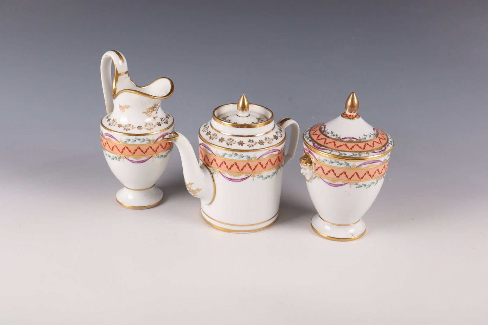 Three service parts: Three service parts Ludwigsburg, around 1800 Consisting of: small pot, cream jug and sugar bowl. Porcelain, painted and gilded. Richly decorated with garlands, festoons and decorative ribbons. The