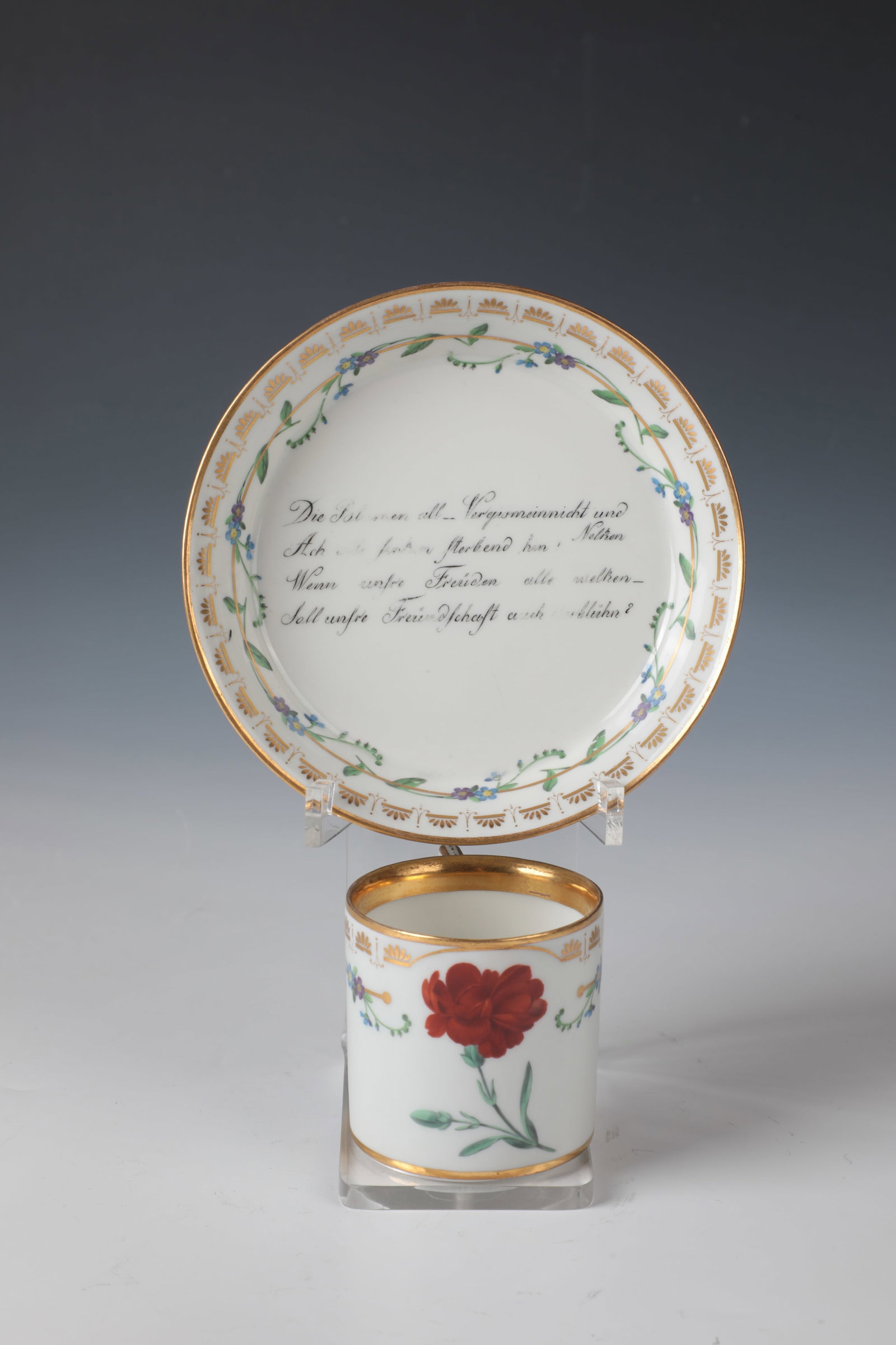 Cup and saucer: Cup and saucer Vienna, c. 1807 Cylindrical cup with edged, gold-heightened handle. On the front side with red carnation in fine polychrome painting between finely painted scattered flowers.