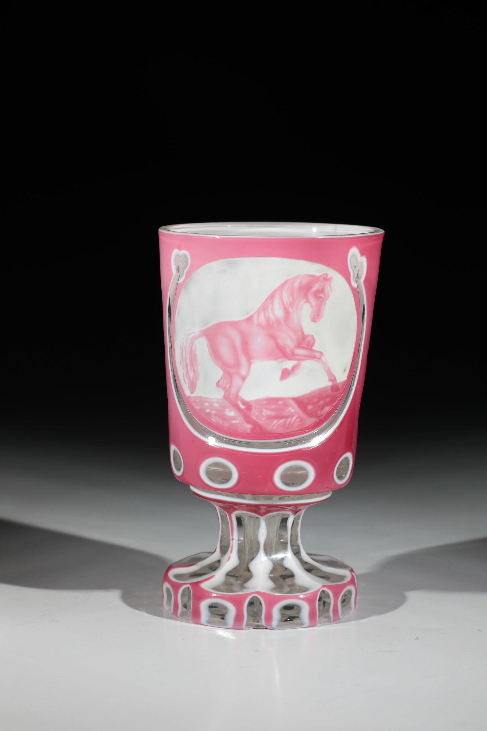 Foot cup with lithophane cut: Foot cup with lithophane cut Bohemia, 2nd half of the 19th century. Faceted ground foot and shaft. Frontal on the almost cylindrical wall medallion with a rising horse. Back rosette of seven