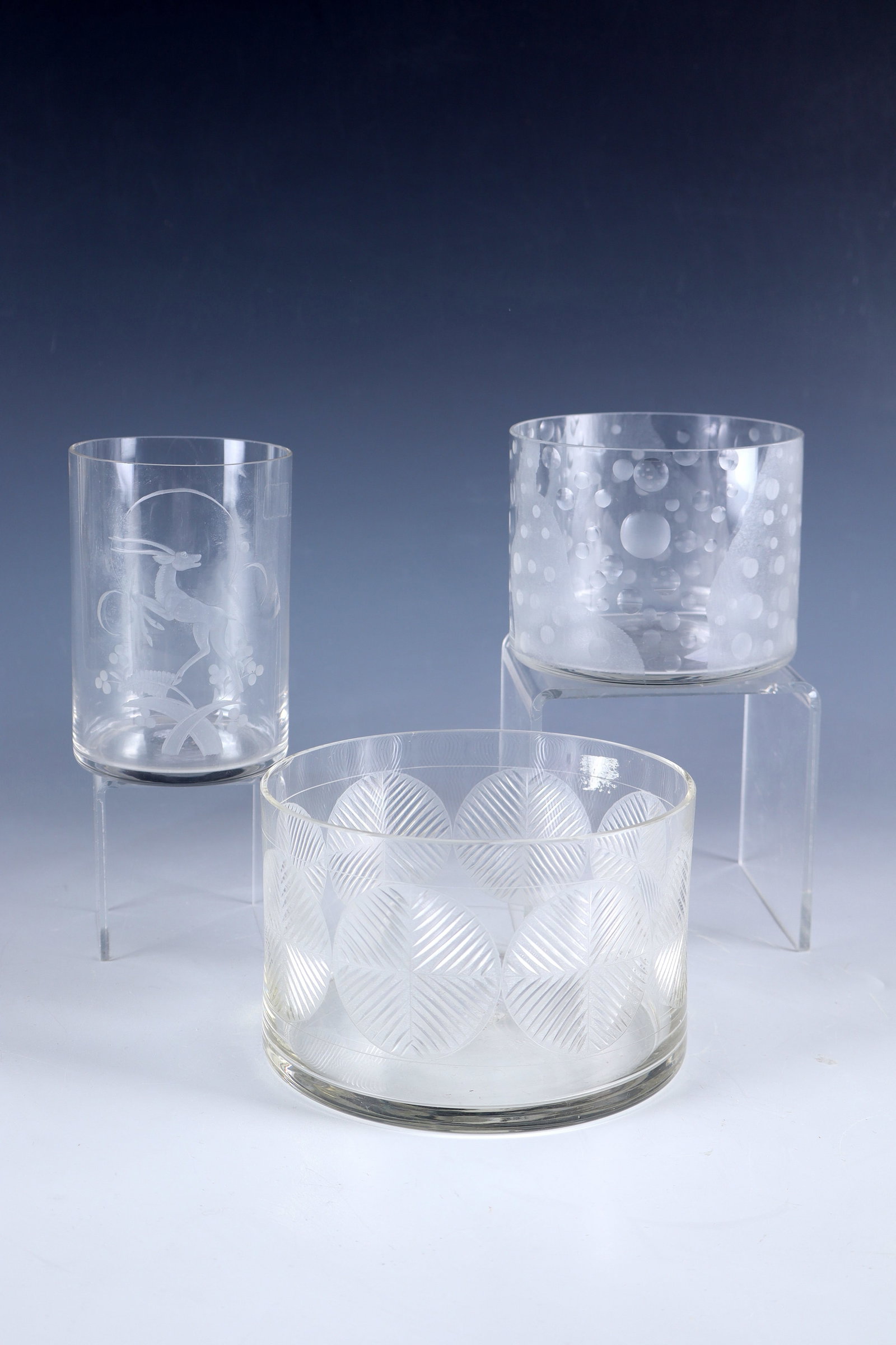 Two bowls and a vase: Two bowls and a vase Wohl Glasfachschule Steinschönau, c. 1990 Colourless glass. Partly abstract geometric decors in wedge-cut, partly polished or matt spherical as well as matt flat sanding. H.