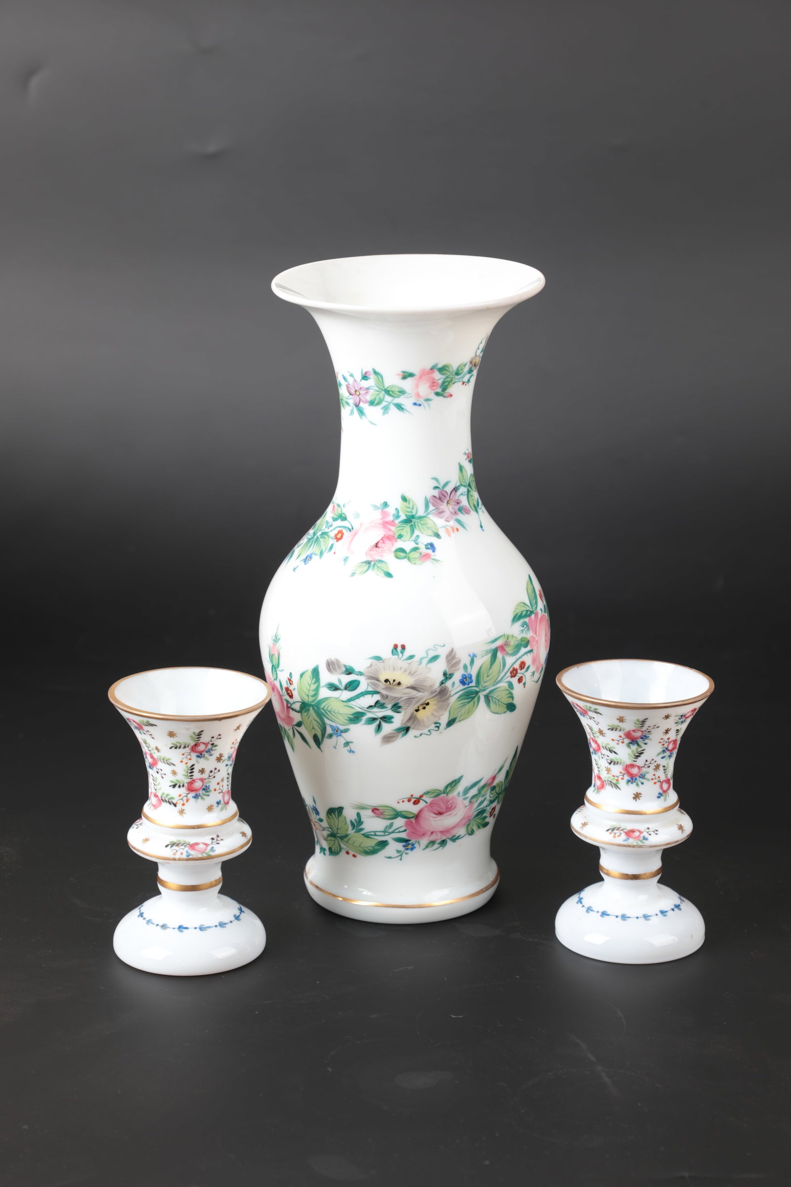 Mixed Lot of 3 Vases: Mixed lot of 3 vases Bohemia, 19th century Baluster vase with spiral flower garland in colourful enamel colours, the mouth and base ring gilded. H. 28.5 cm Pair of vases with bouquets of roses.
