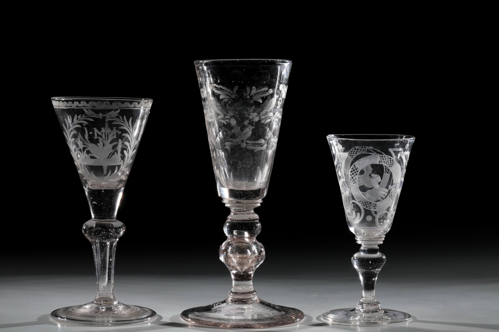 Mixed lot of three trophies: Mixed lot of three cups, Central German, Hesse and Thuringia, 18th century, disc base with folded edge downwards and cut garland. Pseudo-faceted shaft. Conically widened cuppa with flaming heart and