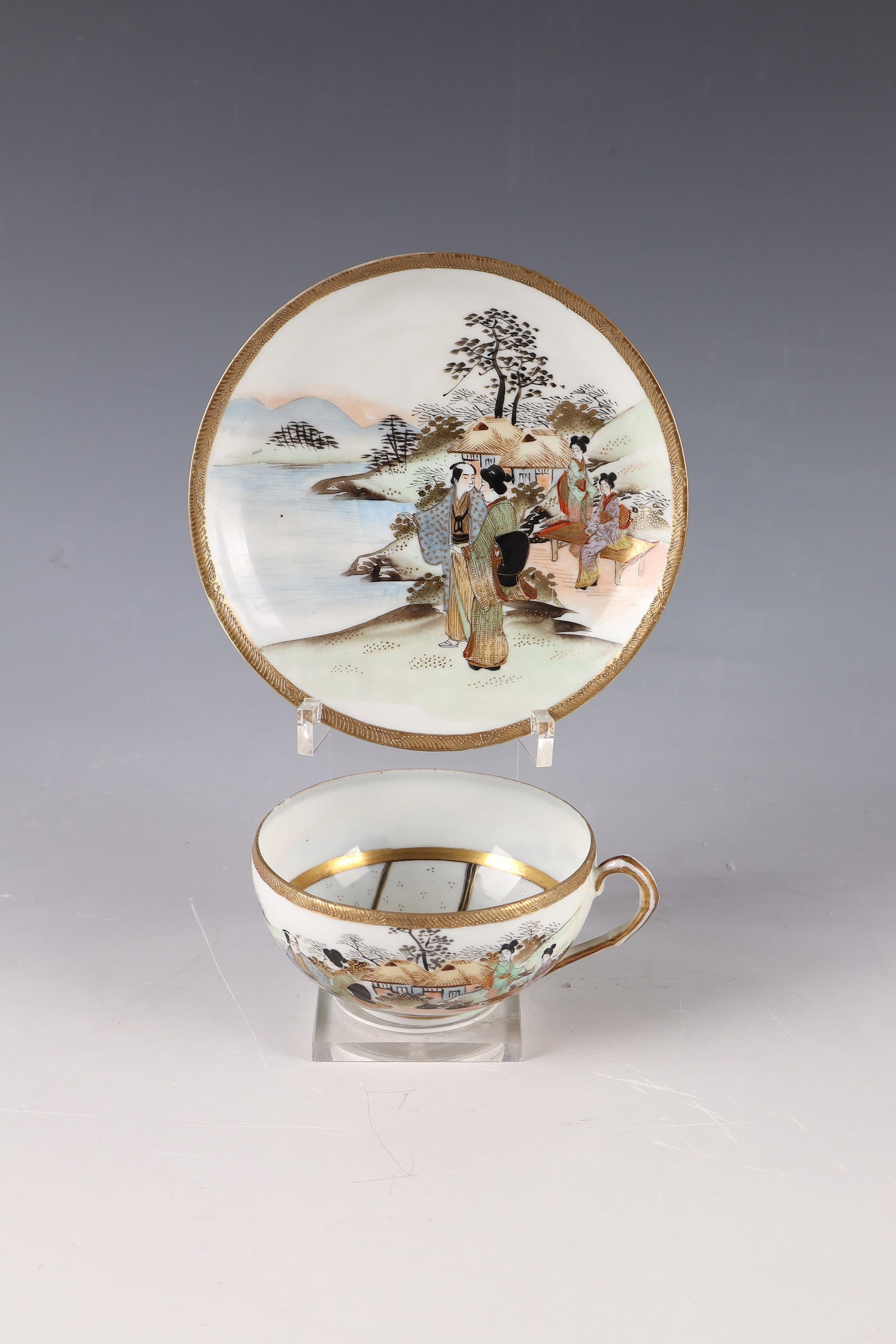 Kutani Mug ''Lovers'': Kutani cup ''Lovers'' Japan, c. 1900, fine porcelain, so-called Kutani. Cup with matching saucer. Outer wall of the cup and the flag of the saucer with finely painted landscape scene: lake with