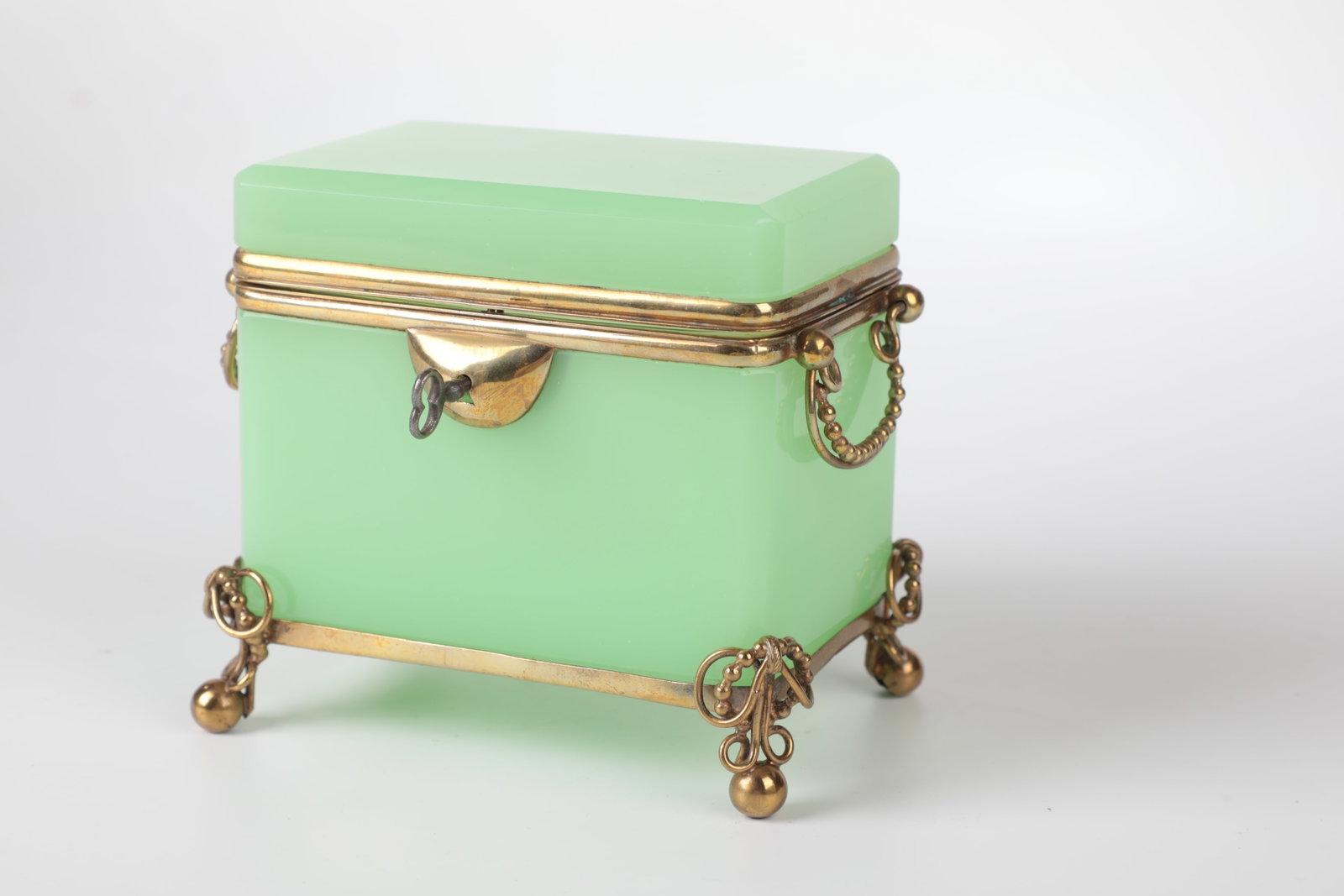 Chrysoprase Glass Lidded Jar: Chrysoprase glass lidded box Bohemia, M. 19th century Alabaster glass colored with uranium. Rectangular with beveled edges. Brass mount. Key provided. 11.5 x 7.5 x 11 cm Chrysoprasglas-Deckeldose