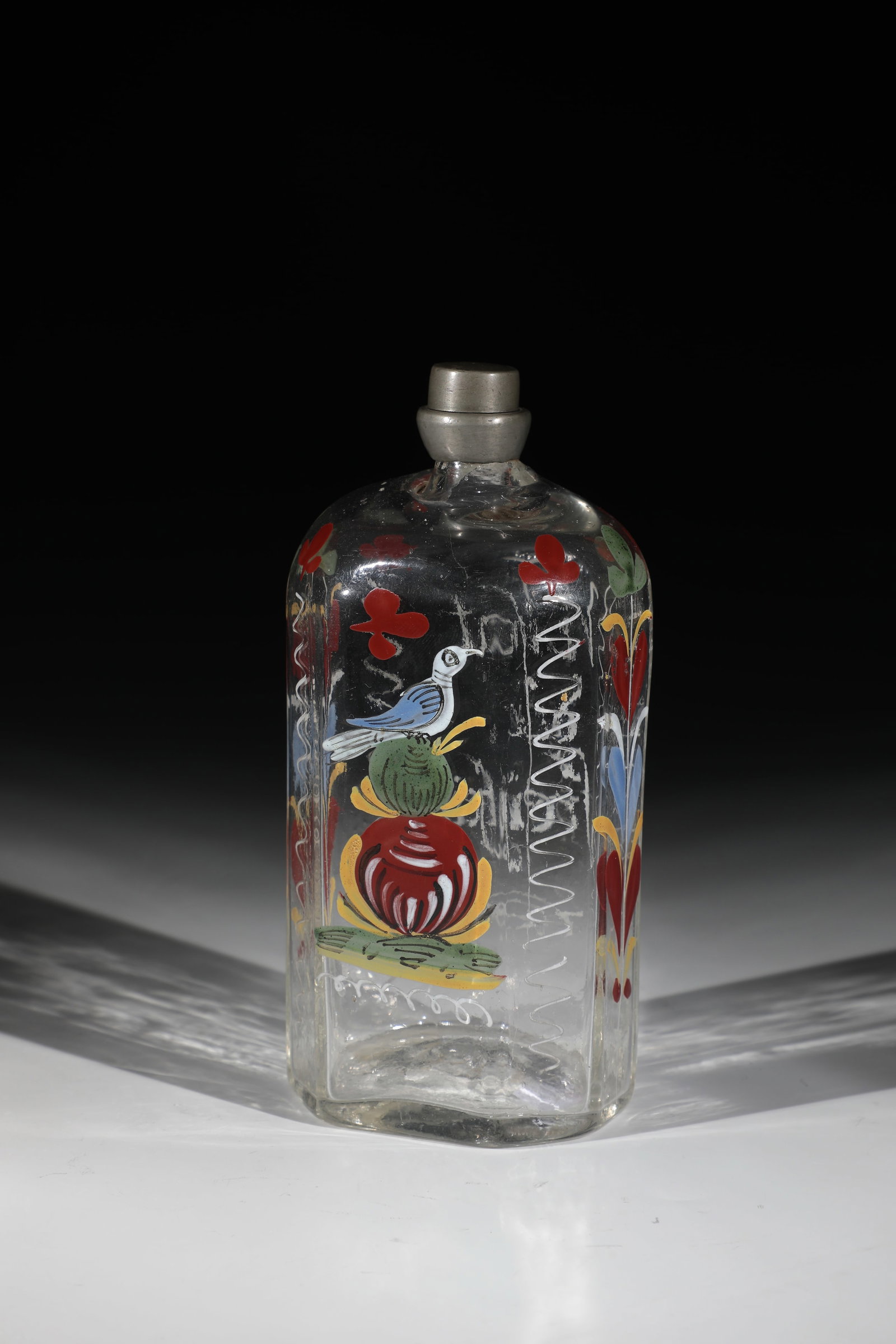 Liquor bottle: Schnapps bottle German, 18th century Colourless glass with tear-off. Frontal on the cross-section rectangular wall with bevelled corners, depiction of a bird in polychrome enamel painting.