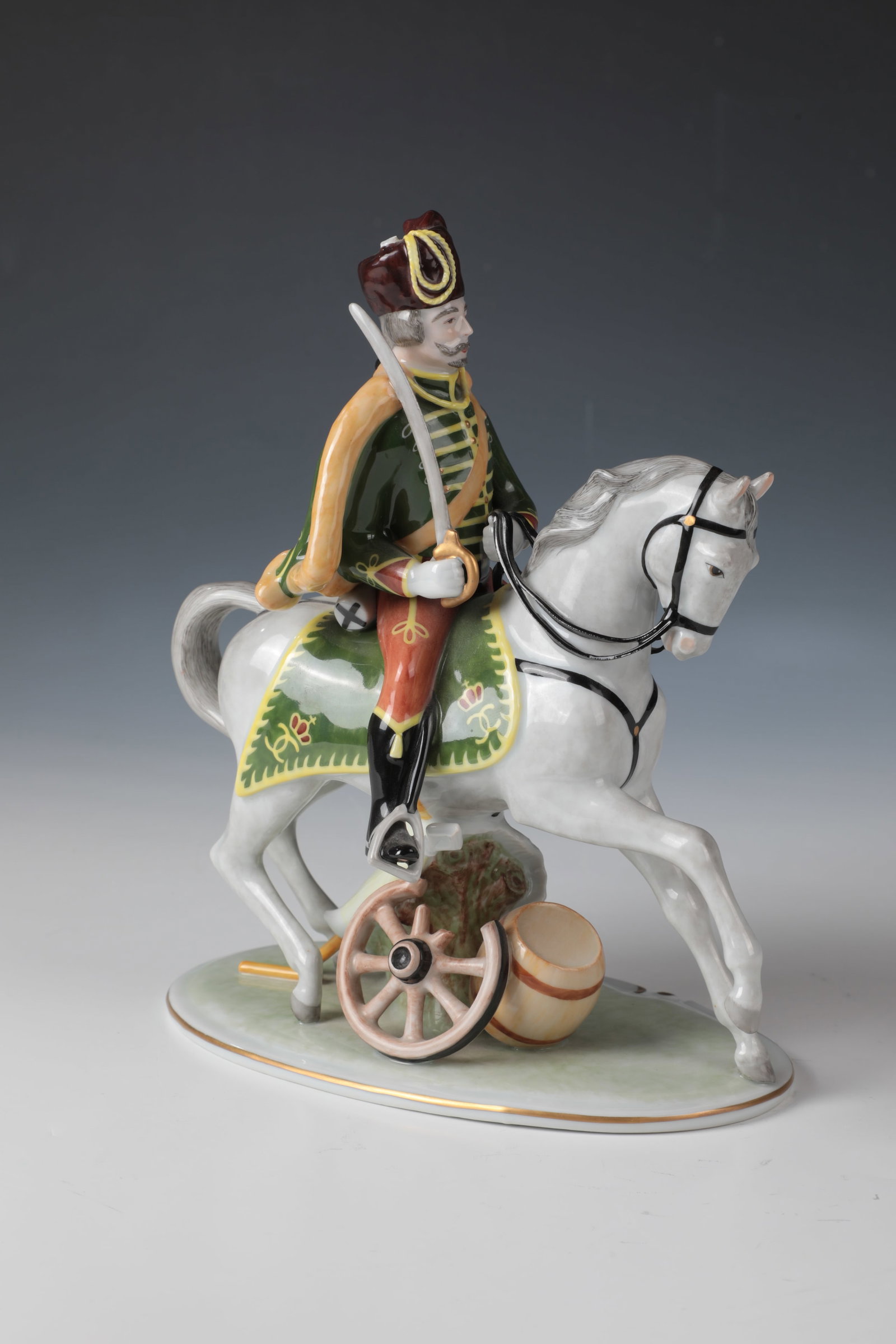 ''Mounted Husar on White Horse'': ''Berittener Husar auf Schimmel'' Ludwigsburg, after 1948 porcelain, polychrome staffed and partially gold-heightened. Oval base with cannon wheel and barrel. Underglaze blue manufactory brand.