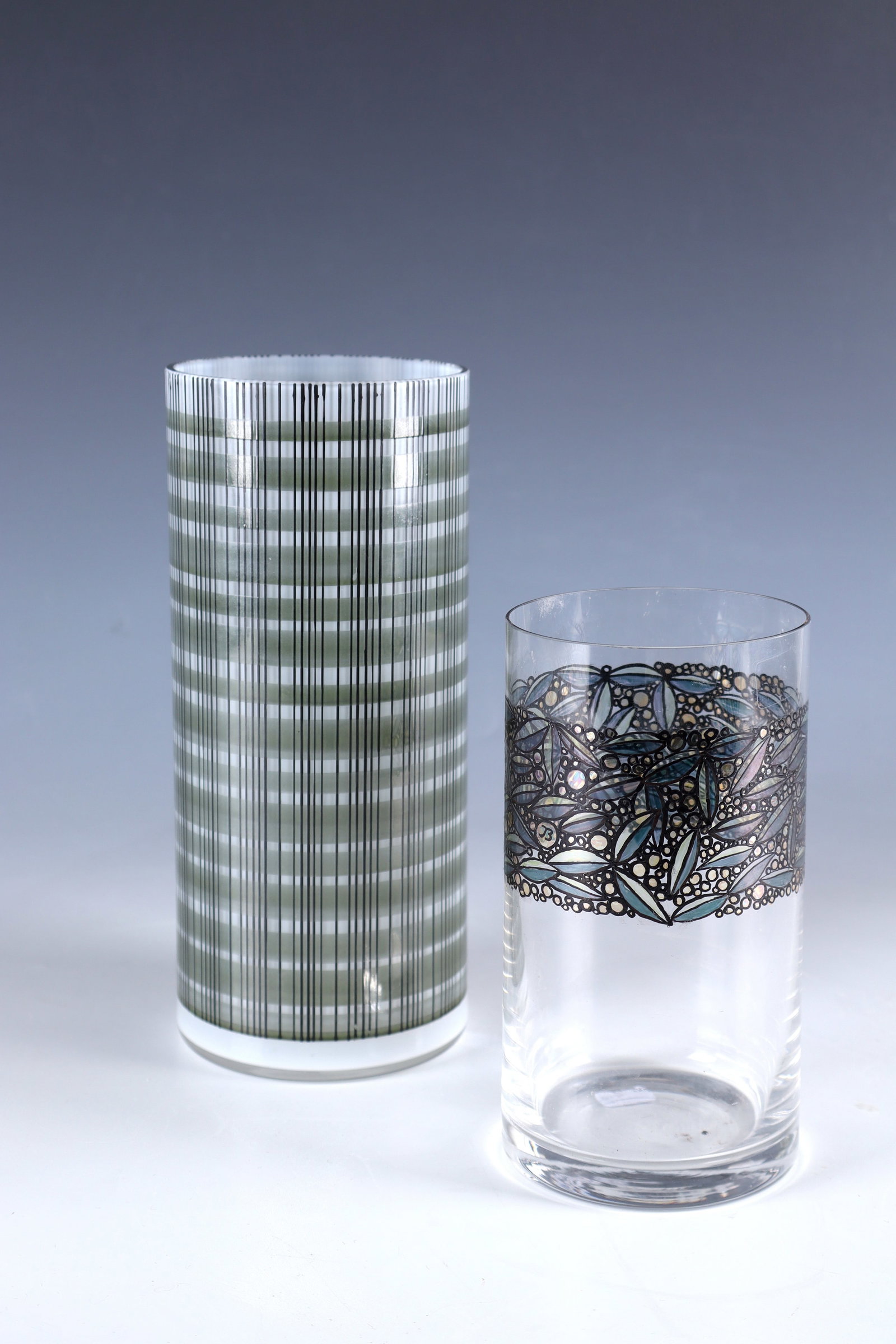 Two vases: Two vases from the Steinschönau or Haida School of Glass, late 20th century Colourless glass, 1x opal white underlay. Multi-coloured floral or geometric enamel decoration all around. A vase in