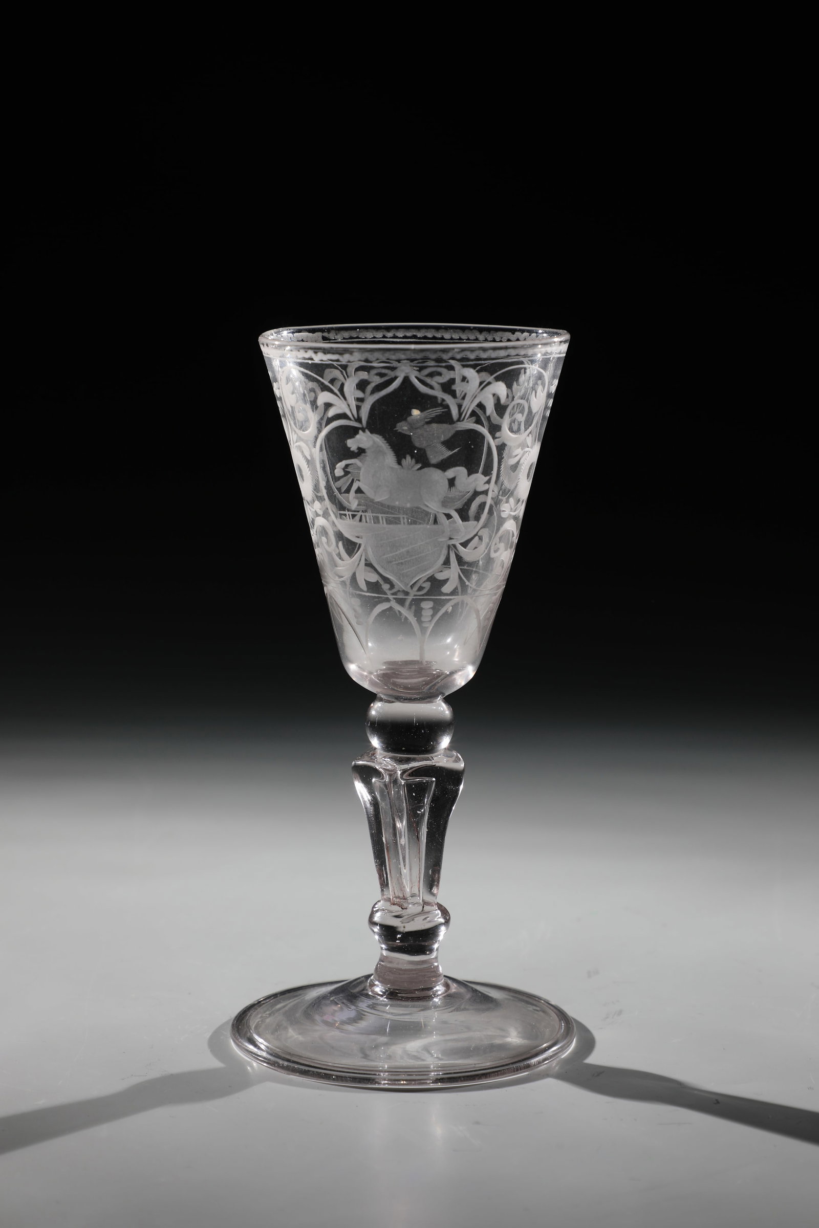 Cup with horse and birds: Goblet with horse and birds Franconia or Thuringia, 18th century. Disc base with the edge folded downwards. pseudo-faceted baluster shaft. On the conically widened Kuppa cartouche with horse or two