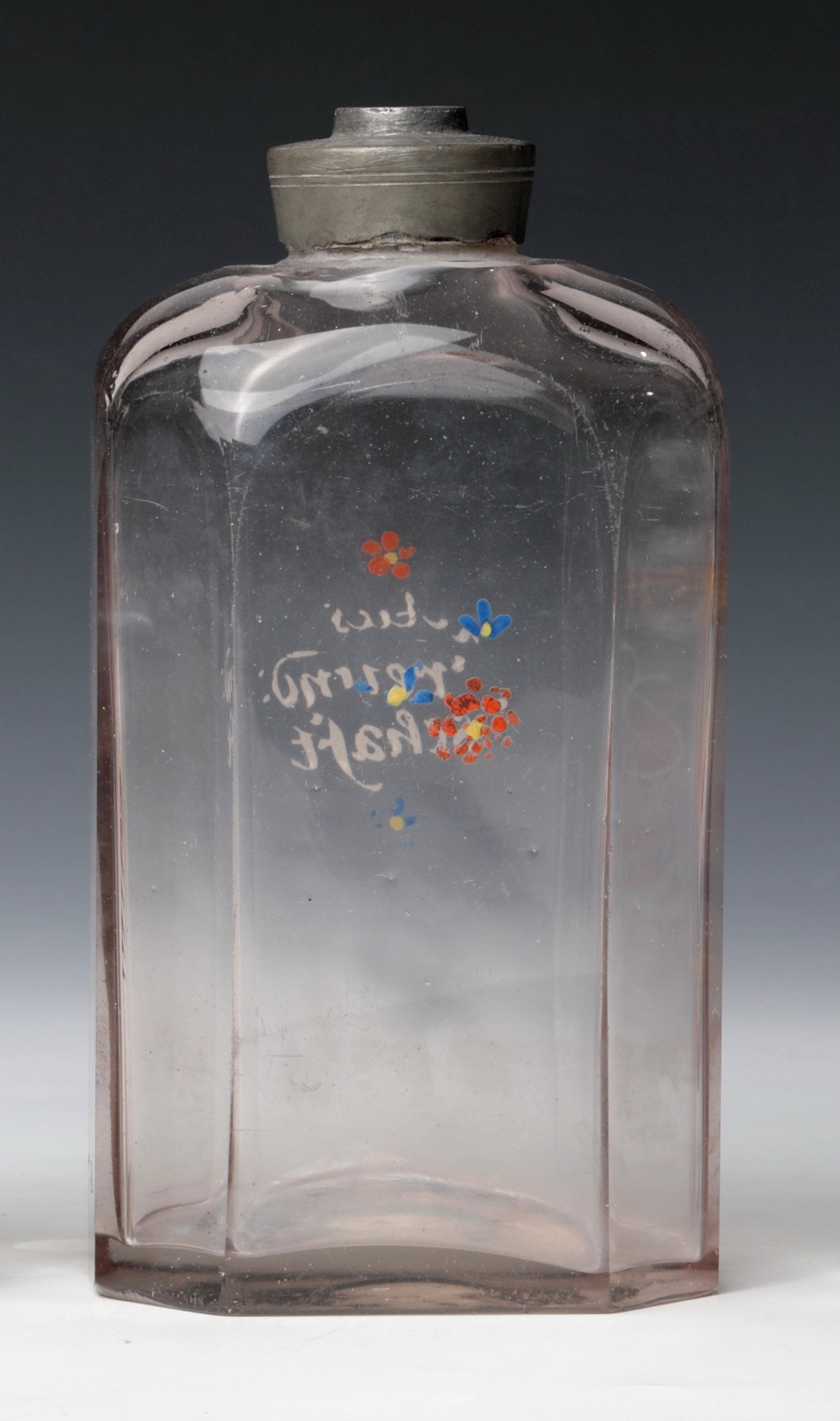 Large liquor bottle with pewter mount: Large liquor bottle with pewter mount German around 1800 Colourless, slightly manganese-tinged glass with ground tear-off. Rectangular wall in cross-section with recessed corners. Polychrome enamel