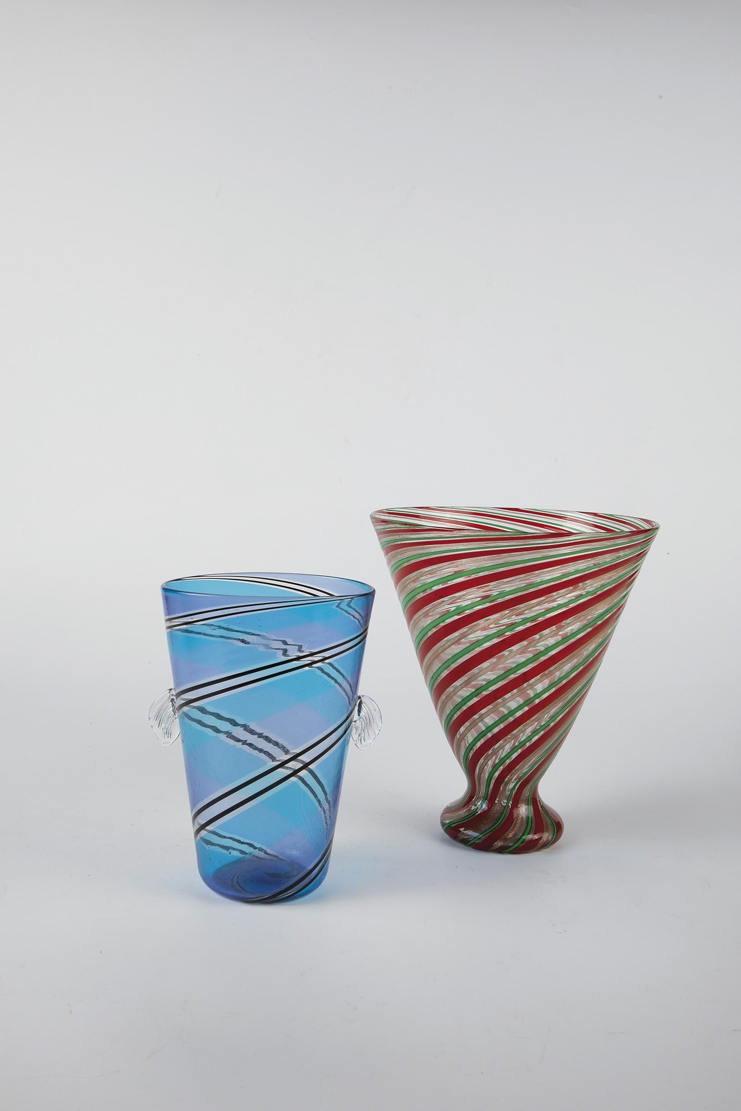 Pair of vases: Pair of Murano vases, 1960s Colourless glass with melted threads in red, green and aventurine or melted ribbons in light blue, light violet and threads in black. Appliqued, pinched handles made of