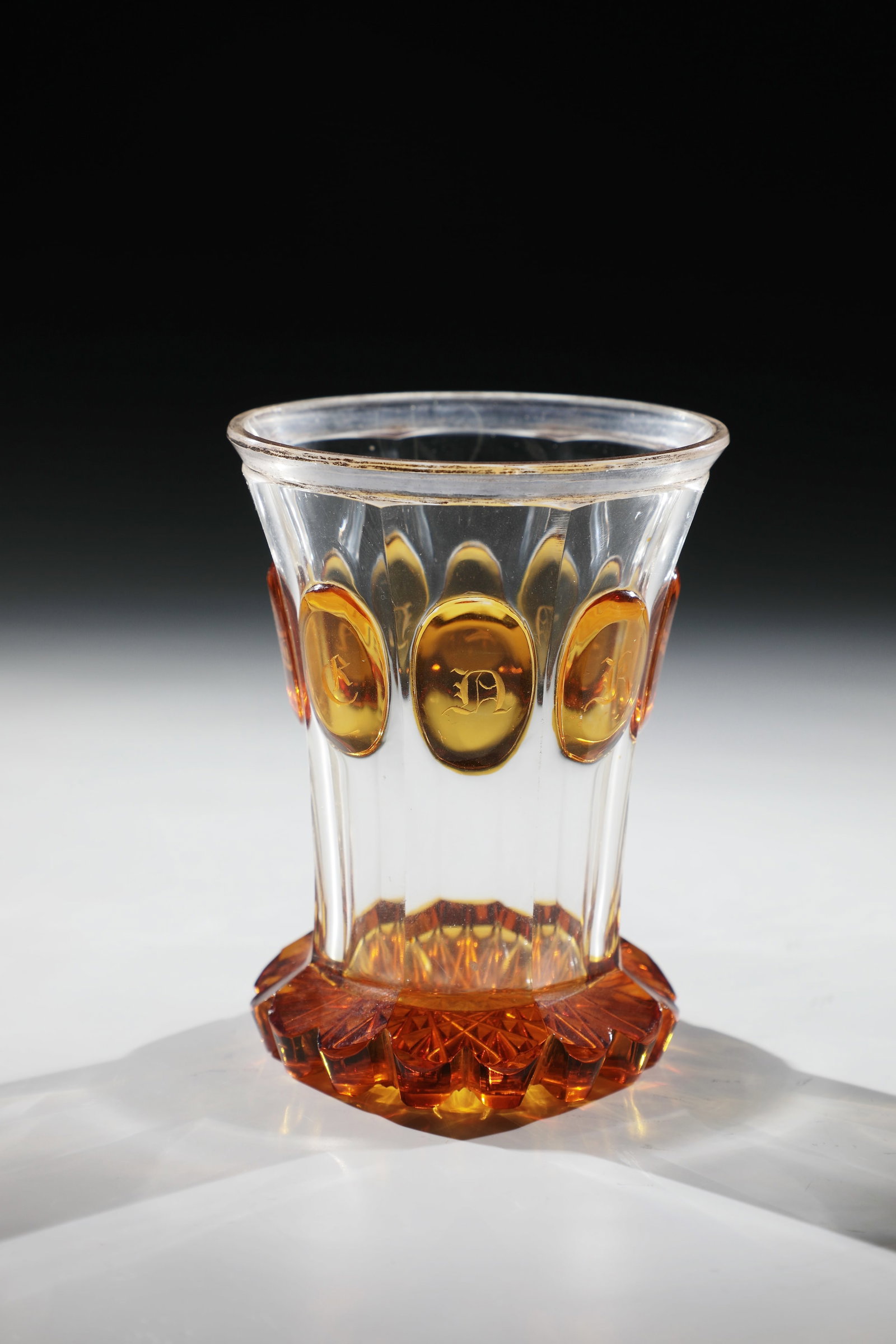 Souvenir Mug: Souvenir mug Bohemia, around 1840 Colourless, cut-decorated and faceted glass. Ranft and high-cut oval medallions amber glazed. Engraved in the medallions: ''Souvenir''. Contrasting lip edge with