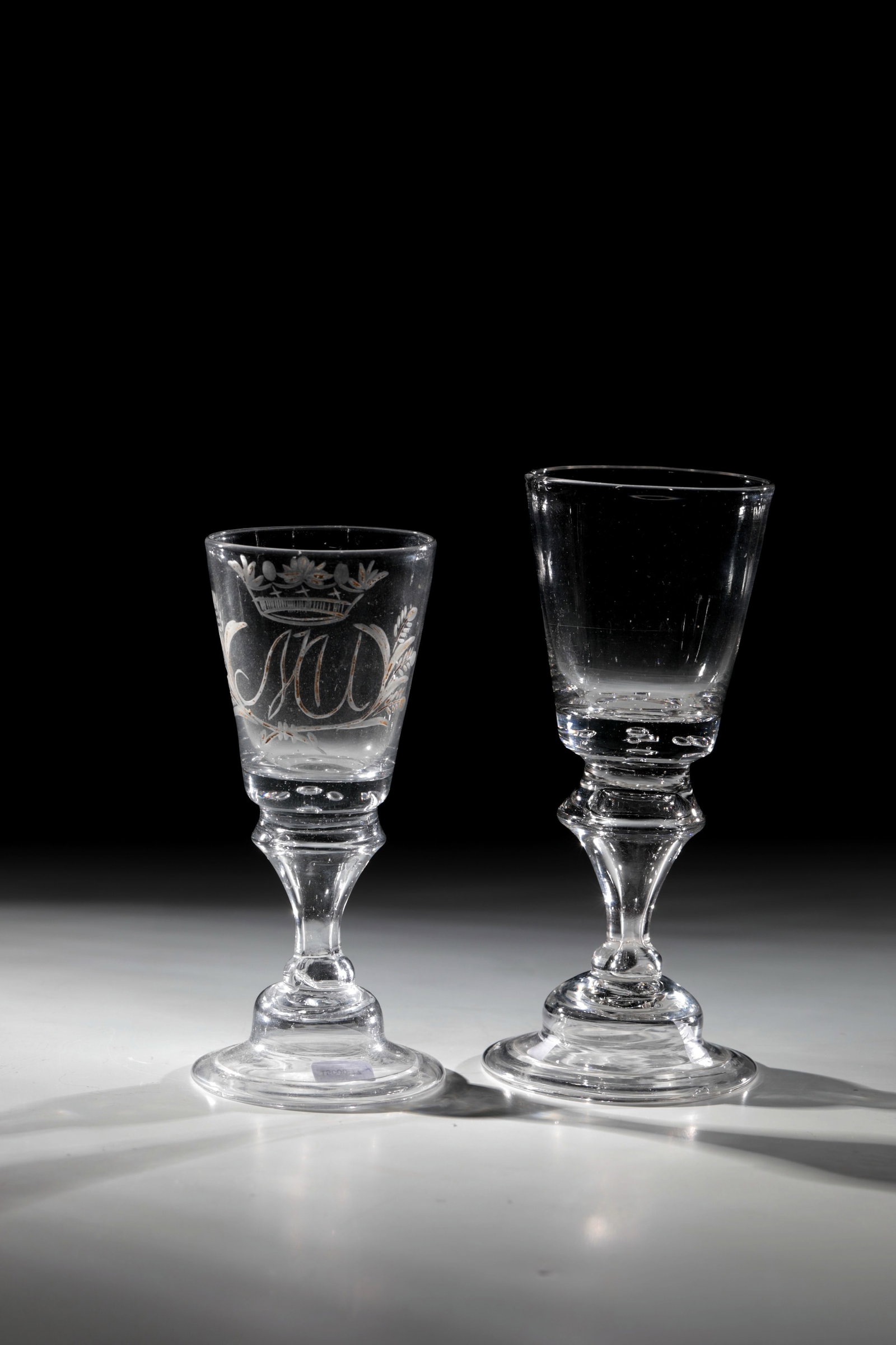 Two Goblets: Two chalices, Norway, Nostetangen, 18th century. Bell-shaped foot with the edge turned downwards. Balusterschaft. Air beads pierced at the base of the dilated cuppa. One with engraved, gilded and crow