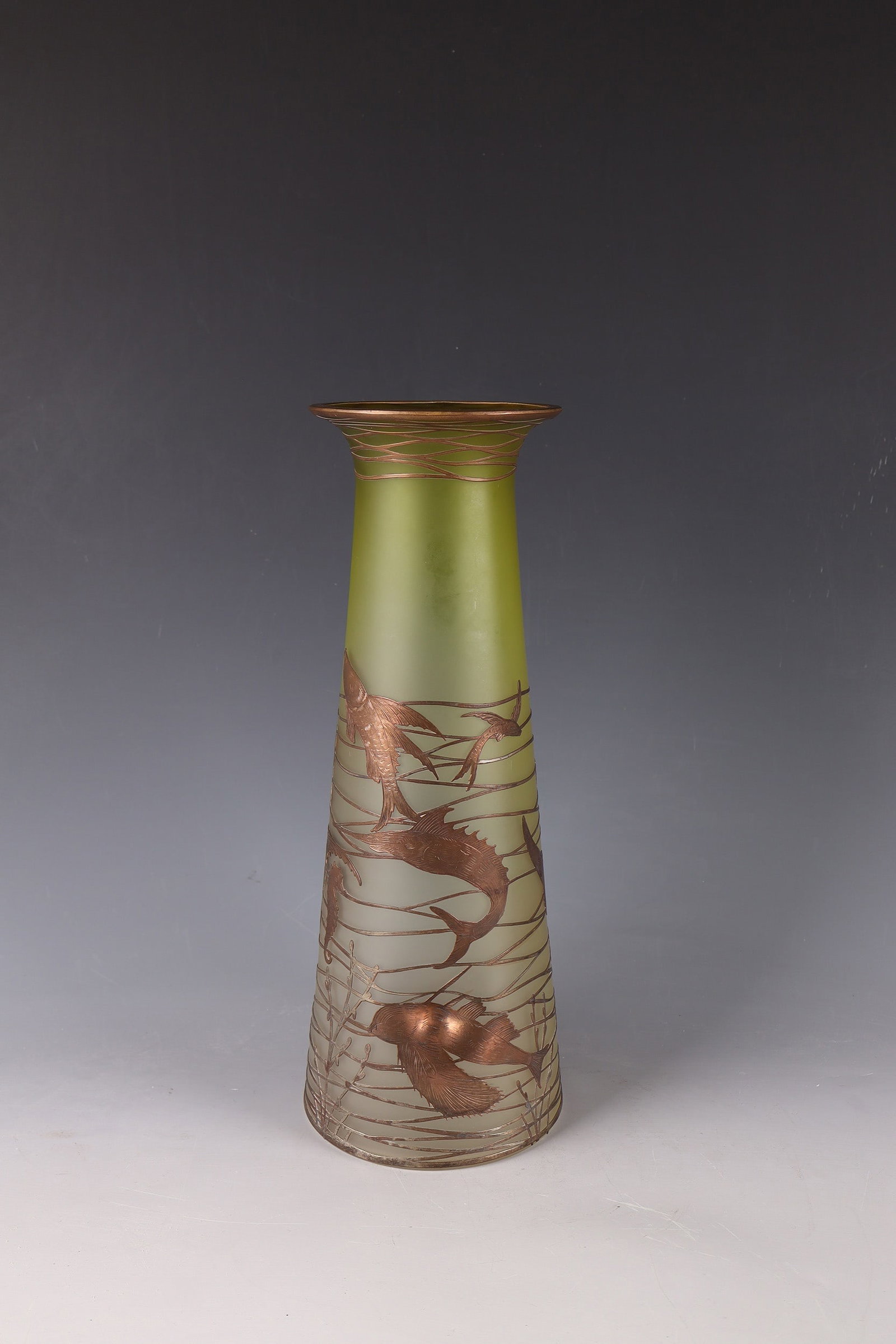 Vase: Vase Bohemia, c. 1920/30 Colourless glass with a light green underlay running downwards. The wall is matted and triple dented in the lower area. All around with engraved copper plating in the form of 