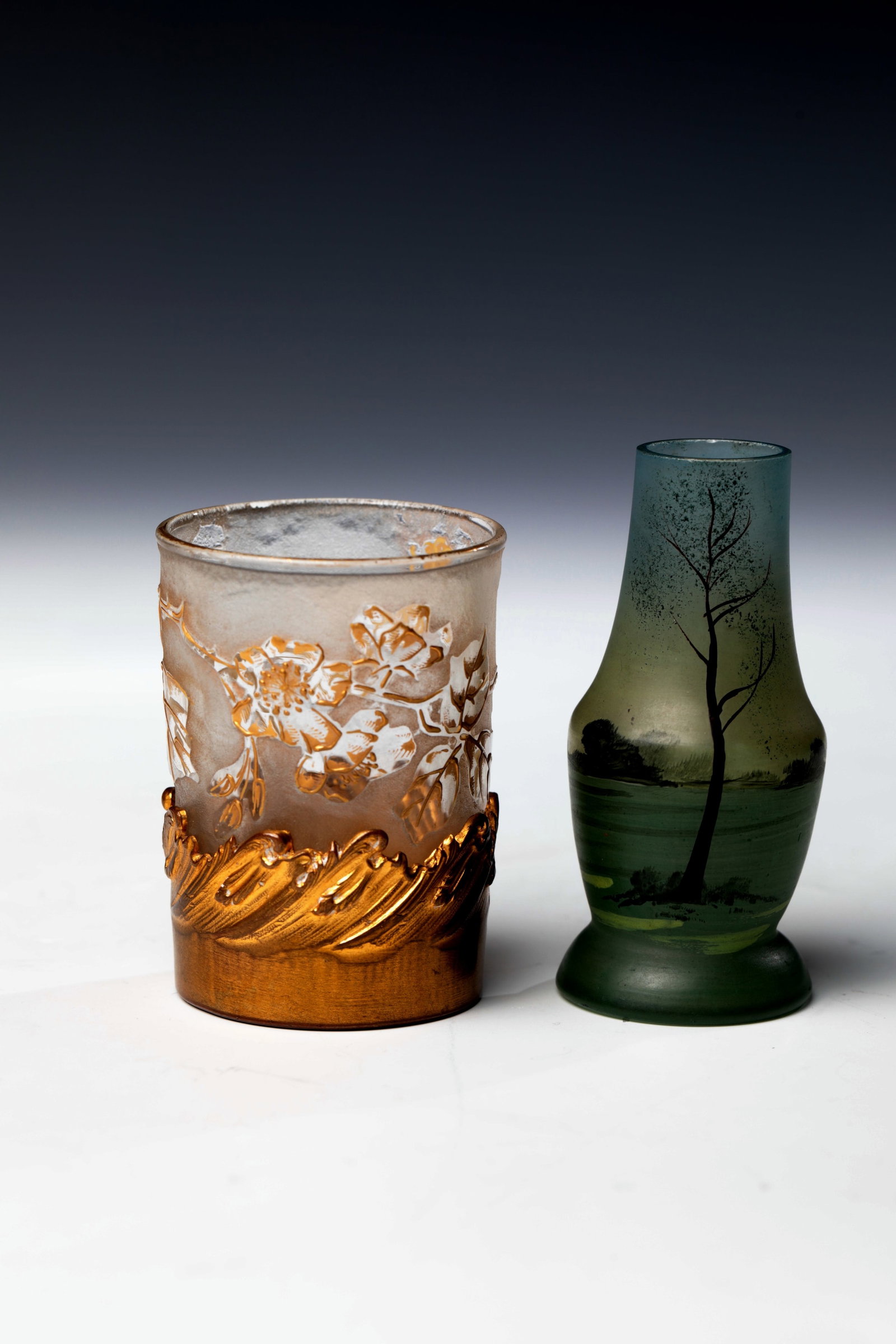 Two Miniature Vases: Two miniature vases France, Legras & Cie., Verreries de Saint-Denis, c. 1910 Colorless glass. Relief etched decoration painted in polished and relief gold: branch with flowers and fruits of the