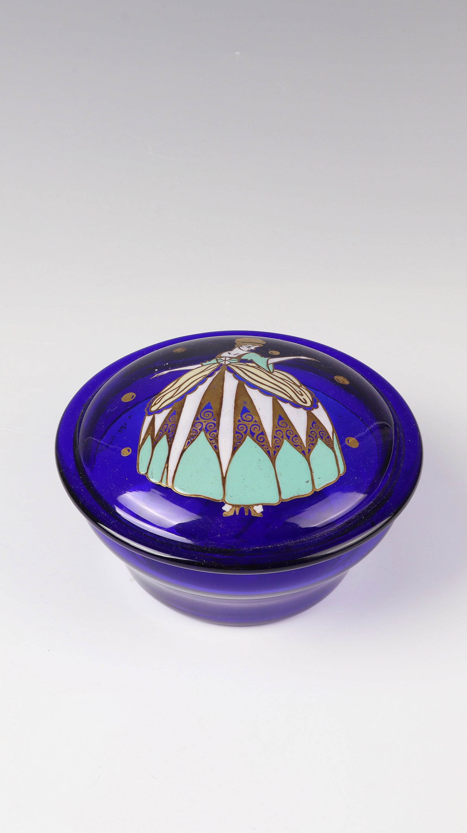 Lidded jar: Lidded box Echinger & Kleiber, Zwiesel, c. 1920/25 Cobalt blue glass with very fine colorful opaque enamel and gold painting. Decor: Elegantly dressed lady in crinoline. H. 8.5 cm; D. 13 cm