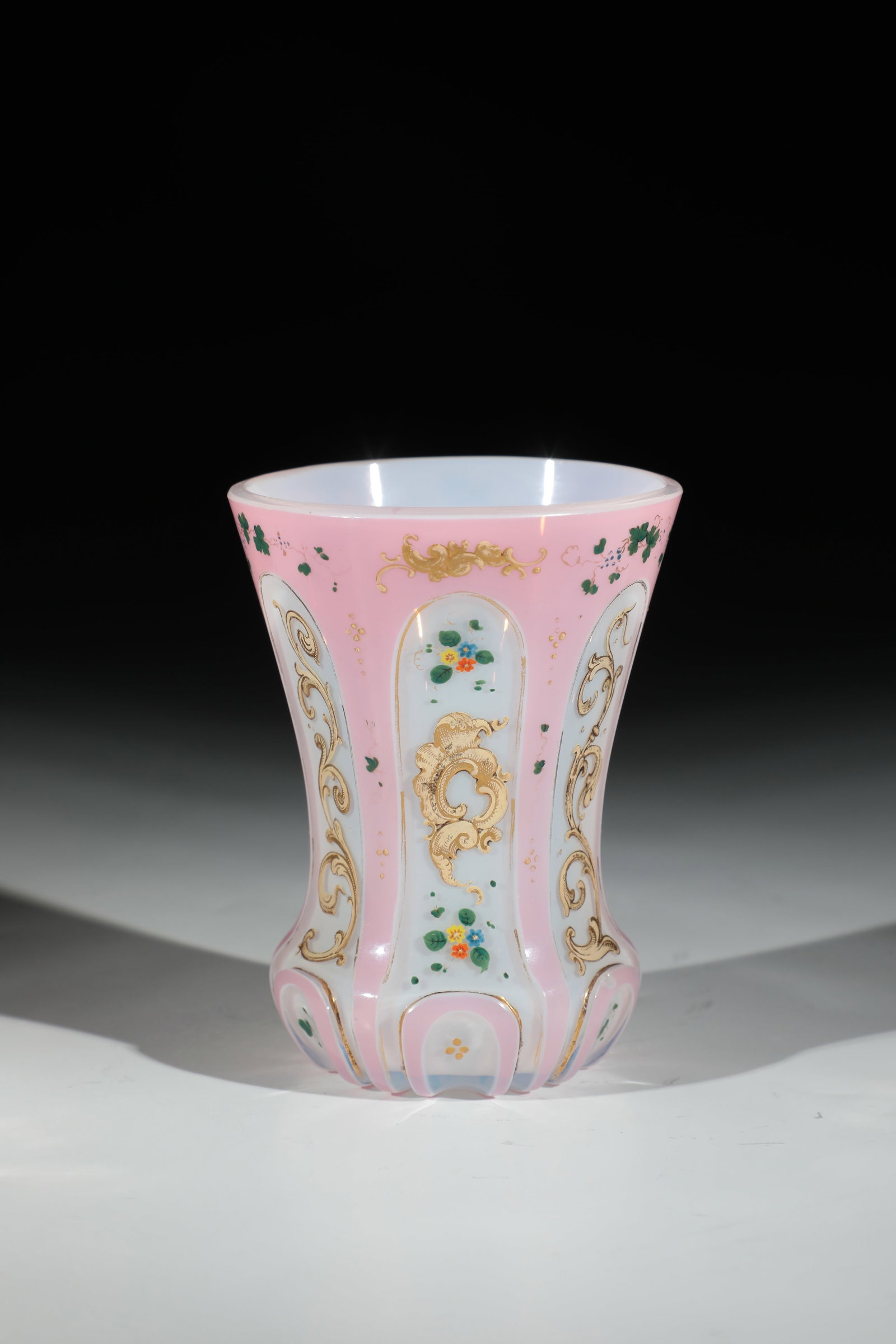 Cups with double overlay: Beaker with double overlay Bohemia, M. 19th century Colourless glass with tin enamel overlay and overlay as well as pink overlay. Highly polished arch ornaments on the ranft, facets peeled above them 