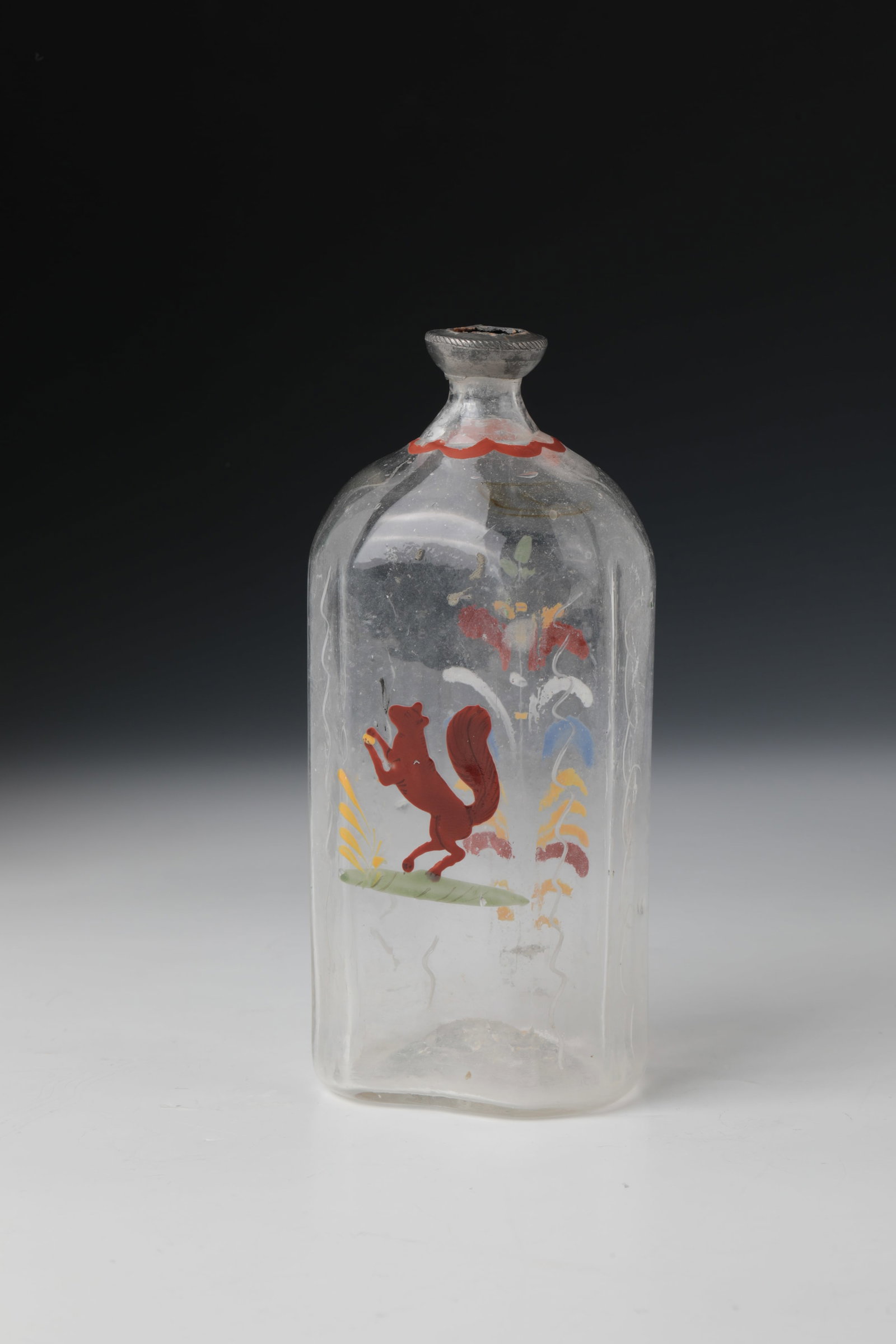 Liquor bottle with fox: Schnapps bottle with fox German, 18th century Colourless glass with tear-off. Rectangular wall with bevelled corners. A fox in polychrome enamel painting on the front, a stylized flower bush on the