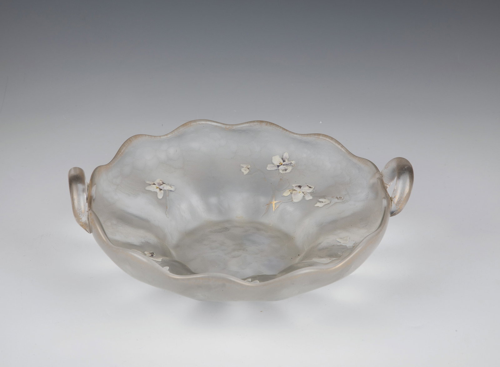 Decorative handle bowl with violets: Decorative Bowl with Violets Daum Frères, Nancy, c. 1898 Colourless glass. Flat etched decoration all around: branches with flowers and foliage of the violet. The flowers are made of opaque