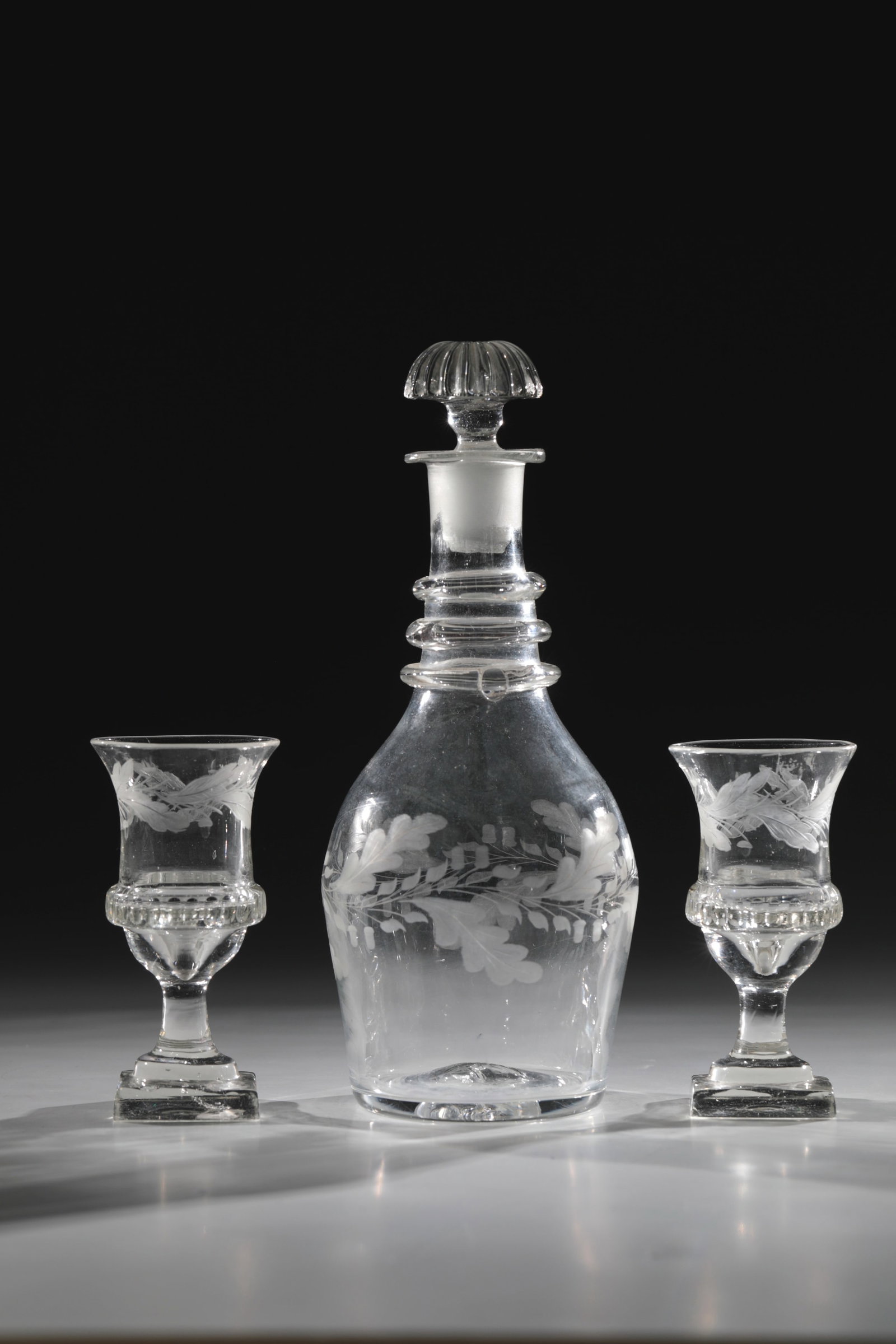 Pair of Small Empire Goblets and Carafe with Stopper: Pair of small Empire goblets and carafe with stopper German, probably Baruth, c. 1820/50 Square plinths with bottom ball, bell-shaped cuppa with notched decoration on bulge. Below the protruding