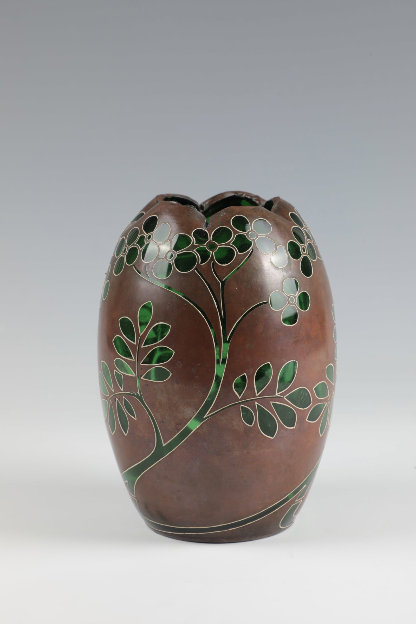 Vase: Vase Wohl Bohemia, c. 1900 Light green glass. Dark patinated copper body with openworked, finely enamelled contoured stylised flower and leaf decoration. Quintuple lobed muzzle rim. H. 18 cm Vase