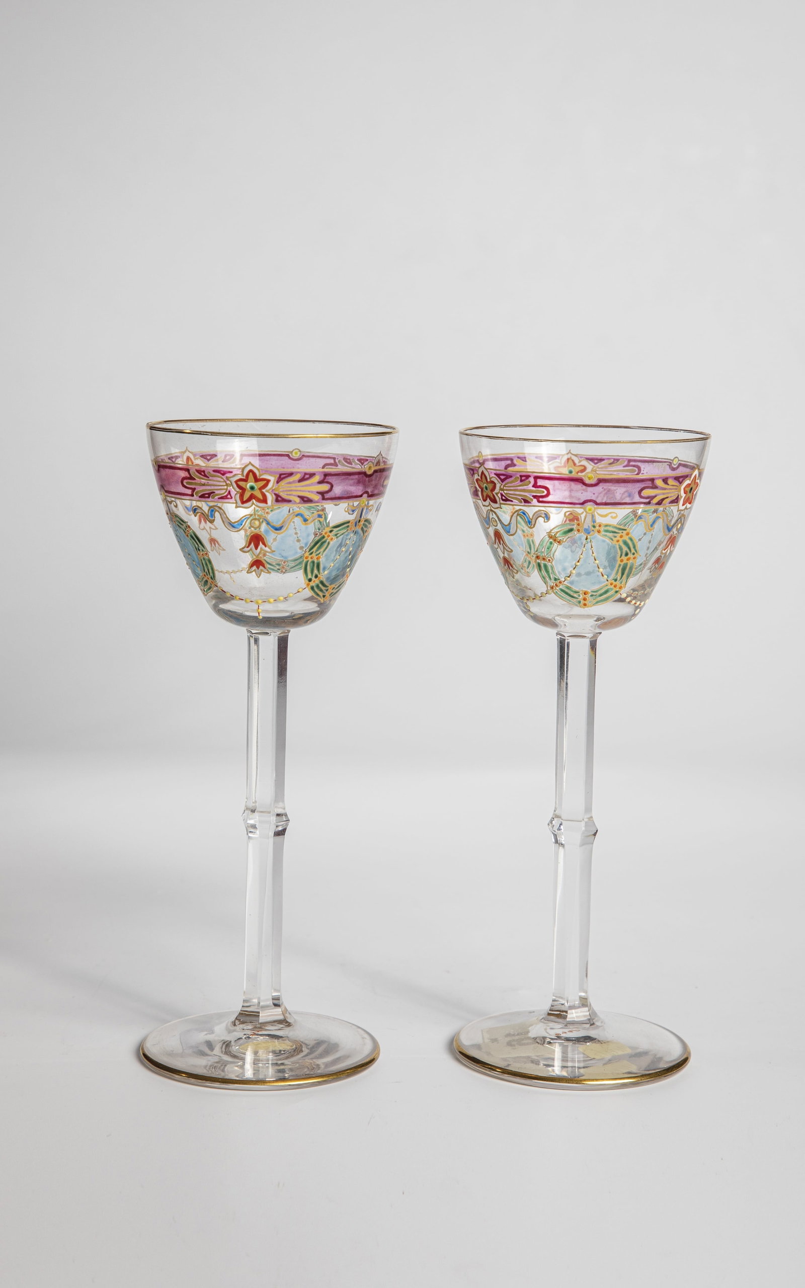 Pair of stem jars: Pair of stem glasses Meyr's nephew, Adolf, around 1900 Colourless, partly faceted cut with a repeated, gold-contoured, polychrome transparent enamel decoration: plant styles. Contour and interior