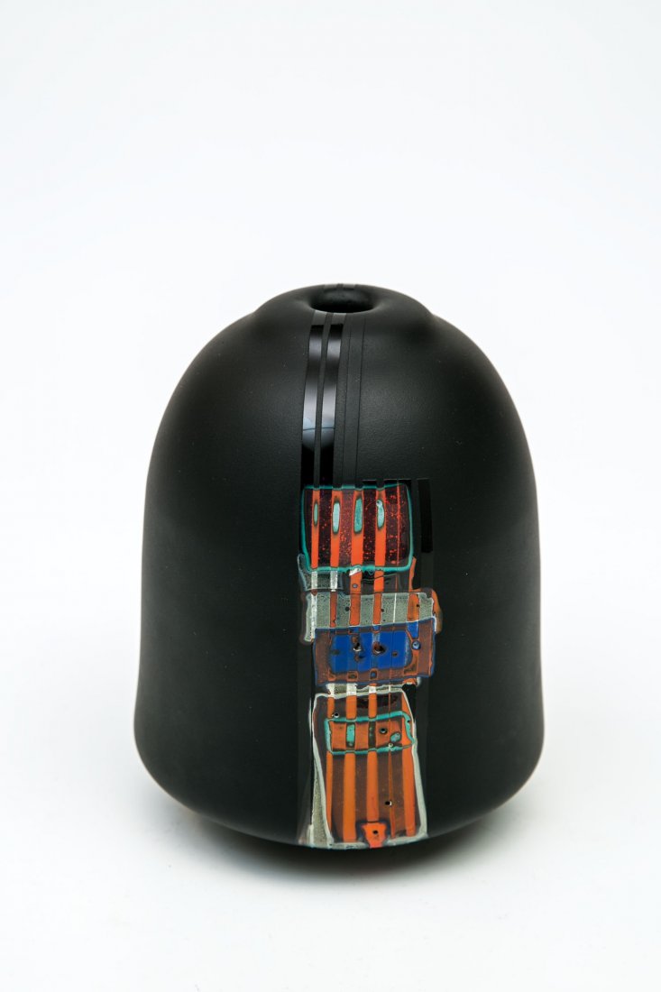 Vase: Vase Joel Philip Myers, um 1980 Schwarz erscheinendes dunkelviolettes Glas, mit eingeschmolzenen, sich überlagernden mehrfarbigen Glasplättchen, sandgestrahlt, partiell poliert. Oberhalb des Standes