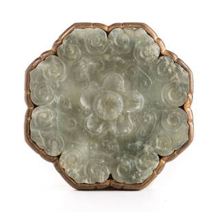 Chinese Jade and Gilt Brass Belt Ornament: Chinese celadon jade and gilt brass belt ornament, carved in the form of a flower head with Ju-i head border and mounted on a conforming gilt brass base with engraved foliate designs. 3" dia. Late