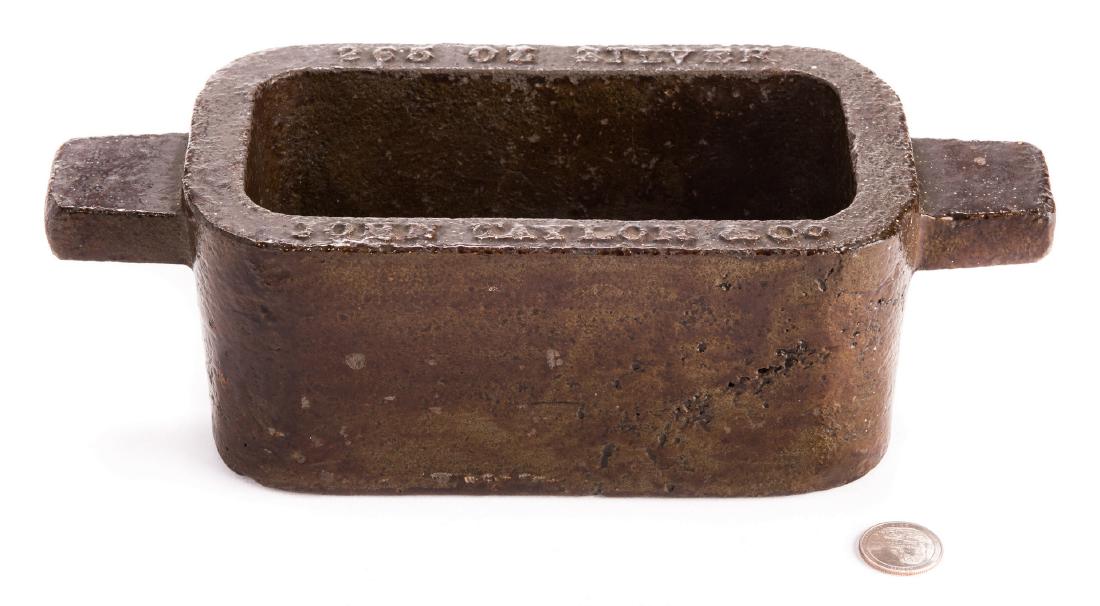 John Taylor & Co. Silver Ingot Mold: John Taylor and Company cast iron 265 oz silver ingot mold with two side handles. Embossed 265 OZ SILVER/JOHN TAYLOR & Co, surface of mold. 3 1/2" H x 11 1/2" W x 4 5/8" D. American, mid/late 19th cen