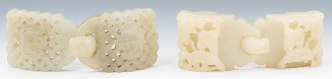 2 Chinese Celadon Jade Double Belt Buckles: 1st item: Chinese celadon jade double belt buckle, carved with dragon and openwork design, chilong dragon hook. 3 7/8" L. 2nd item: Chinese pale celadon jade double belt buckle, carved with pierced