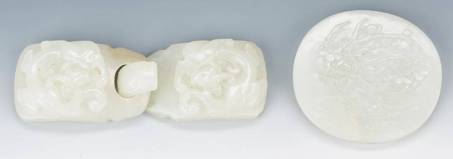 2 Chinese Celadon Jade Belt Buckles: 1st item: Chinese pale celadon jade double belt buckle, carved with dragon motif, chilong dragon hook. 4 1/8" L. 2nd item: Chinese pale celadon jade belt buckle, oval form with carved flowering tree