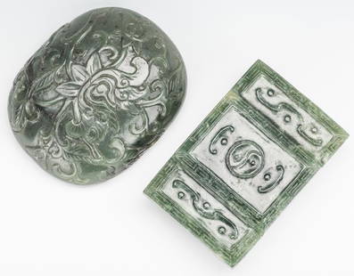 2 Chinese Spinach Jade Buckles: 1st item: Chinese carved spinach jade belt buckle, rectangular form with scrolling decoration and fretwork border. 1 7/8" H x 2 3/4" W. 2nd item: Chinese carved spinach jade belt buckle, oval form