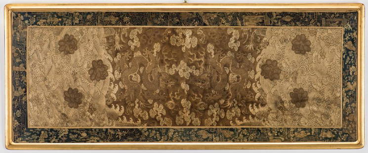 Chinese Qing Silk Embroidery: Framed Chinese Qing Dynasty silk embroidered double panel with blue sash border, seamed at center, image in various shades and stitches of gold depicting two opposing five-toed dragons chasing a