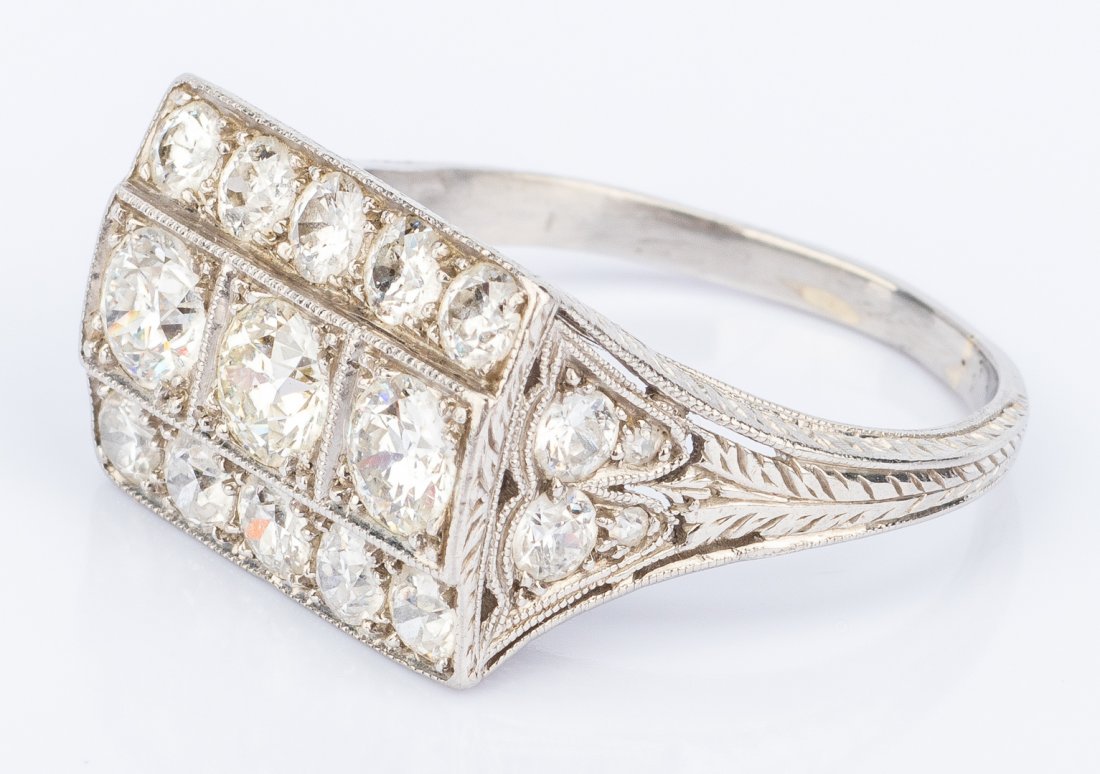 Art Deco Platinum Diamond Ring: One ladies Art Deco platinum and diamond stack style filigree ring, 2.66 ct total weight, containing 3 round European cut center row diamonds weighing 1.20 cts. t.w., 14 round European cut diamonds wi