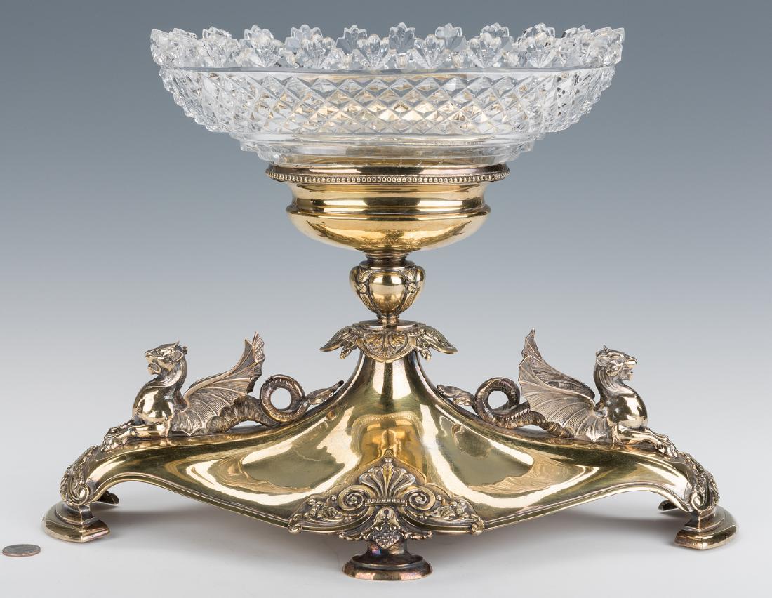 Elkington Gilt Centerpiece with Cut Glass Bowl: Elkington Neoclassical style gilt and silver plated centerpiece or epergne with heavy cut crystal oval bowl, resting on the oval pedestal of a footed base with figural griffins at each end and molded 