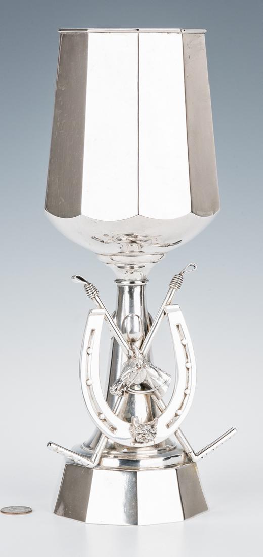 Equestrian Themed Silver Trophy Cup: Equestrian themed silver trophy or presentation cup, modeled as an oversized goblet with figural horseshoe and crossed polo mallets, fronted by the bust of a horse and a fox, raised atop a ten-sided b