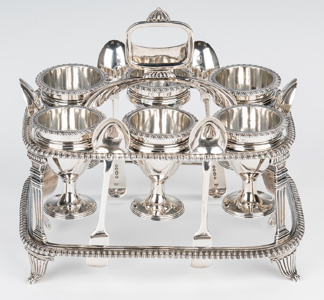 Edwardian Sterling Egg Cruet and Spoons: Edwardian Sterling silver egg cruet, oblong openwork frame with gadrooned edges and corner supports in the form of Greek columns, oblong loop handle with scrolled bridge, and six footed egg cups. All