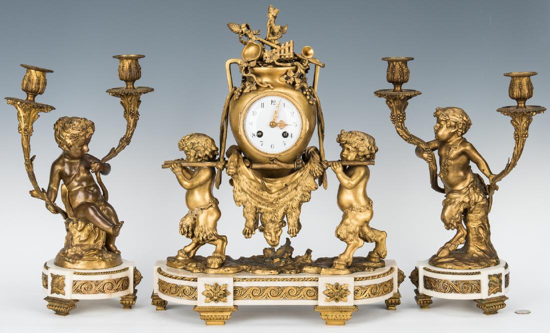 French Ormolu Clock and Garniture, Clodion: French Louis XV style ormolu and marble three piece clock and garniture set; marble bases mounted with gilt bronze cherub figures supporting candelabra signed "Clodion" and 19th century clock adorned
