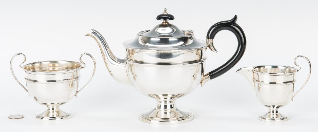 George V Sterling Tea Service, 3 pcs.: Sterling silver tea service, 3 pieces, marks for Sir John Bennett, London, 1932-1933. Teapot, sugar and creamer, all with round bodies and conforming feet, the teapot with ebonized handle and finials.