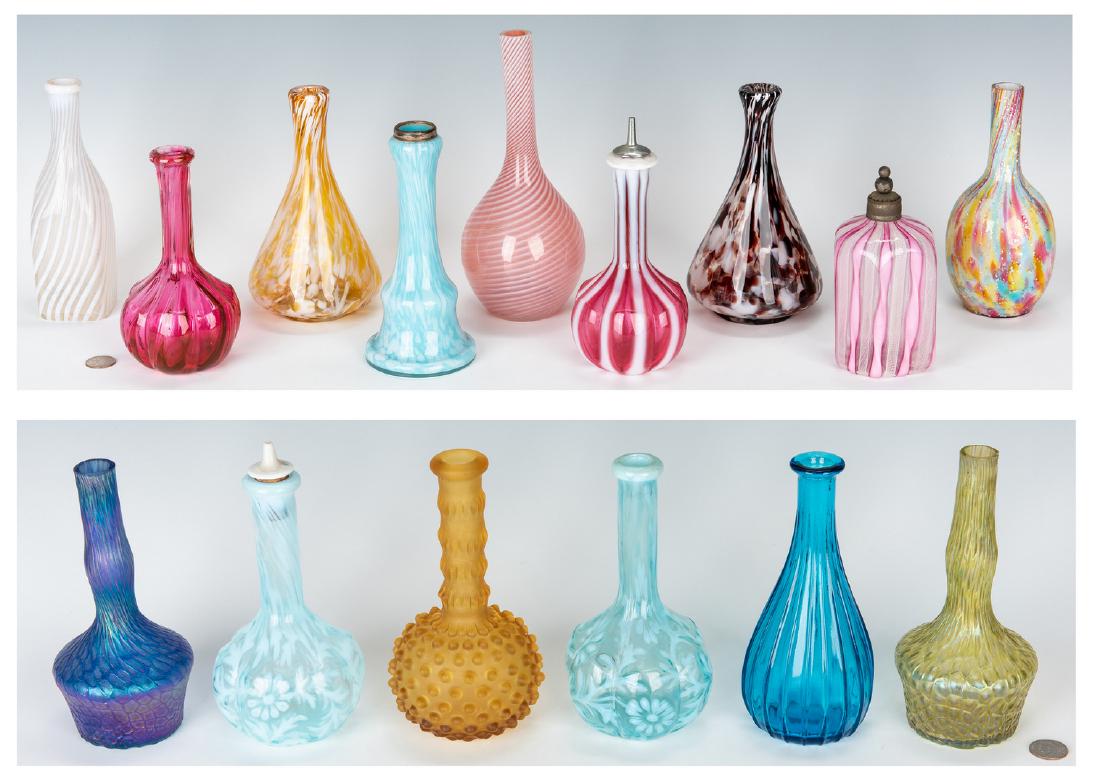 Collection of 15 Art Glass Barber Bottles: Collection of fifteen (15) art glass barber's bottles, including two (2) aqua Fenton glass "Daisy & Fern" pattern examples (one retains the stopper), two (2) Art glass iridescent threaded examples in 