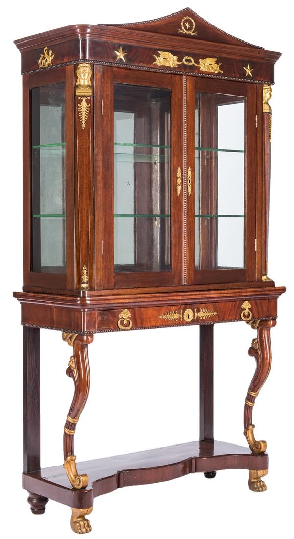 Napoleon III Gilt Bronze-Mounted Vitrine on Stand: Napoleon III ormolu mounted mahogany and mahogany veneer vitrine or bookcase comprised of two pieces. The top with a molded cornice having rounded corners and mounted with a central arched pediment ha