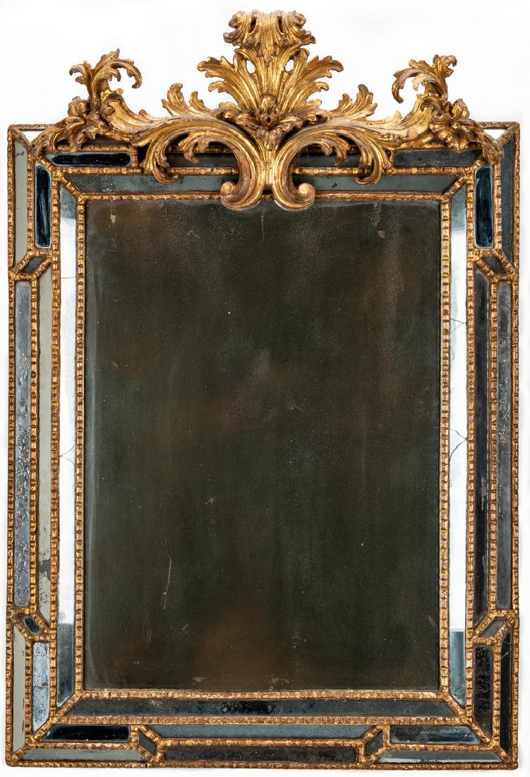 19th Century Carved Giltwood Venetian Mirror: Antique Venetian looking glass, carved giltwood acanthus scroll crest over a canted and mirrored frame with giltwood beaded edging; central rectangular mirror plate. 44" H x 29 1/2" W x 7" D. Italian,