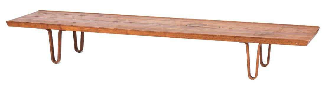 Edward Wormley for Dunbar Coffee Table: Mid-Century Modern walnut coffee table by Edward Wormley for Dunbar. Long rectangular top supported on four elongated, curvelinear legs. DUNBAR, Berne, Indiana brass metal tag to underside. 12" H at c