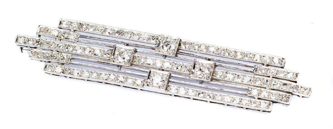 Art Deco Platinum Stacked Diamond Pin: An Art Deco platinum diamond brooch in a stacked bar design, total diamond weight of approximately 1.97 ct, and containing four (4) 3.3 - 3.1mm mine-cut diamonds, SI2/I with total weight of approximat