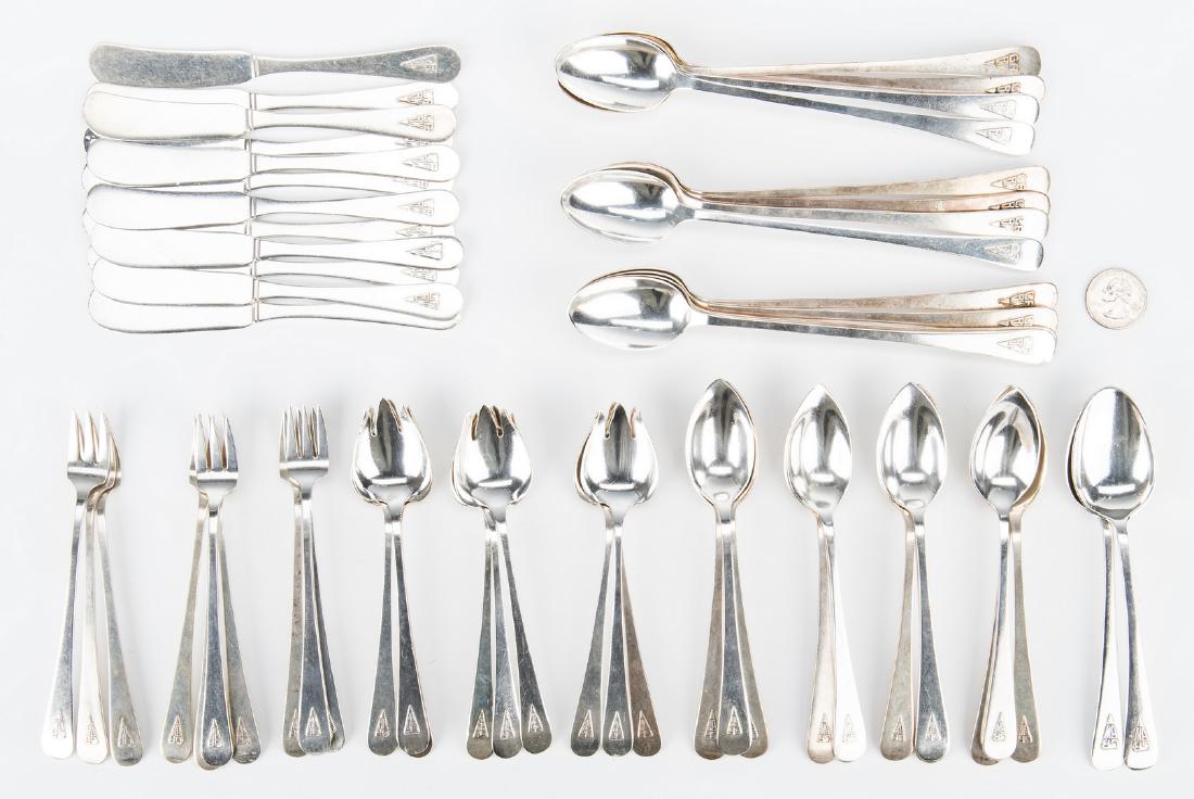 Gorham Sterling Flatware w/ Art Deco Monogram, 56 pcs.: Gorham Mfg. Company sterling silver flatware, Knickerbocker plain pattern, consisting of 12 iced tea spoons, 2 teaspoons, 11 fruit spoons, 9 ice cream forks, 10 seafood forks, and 12 individual butter
